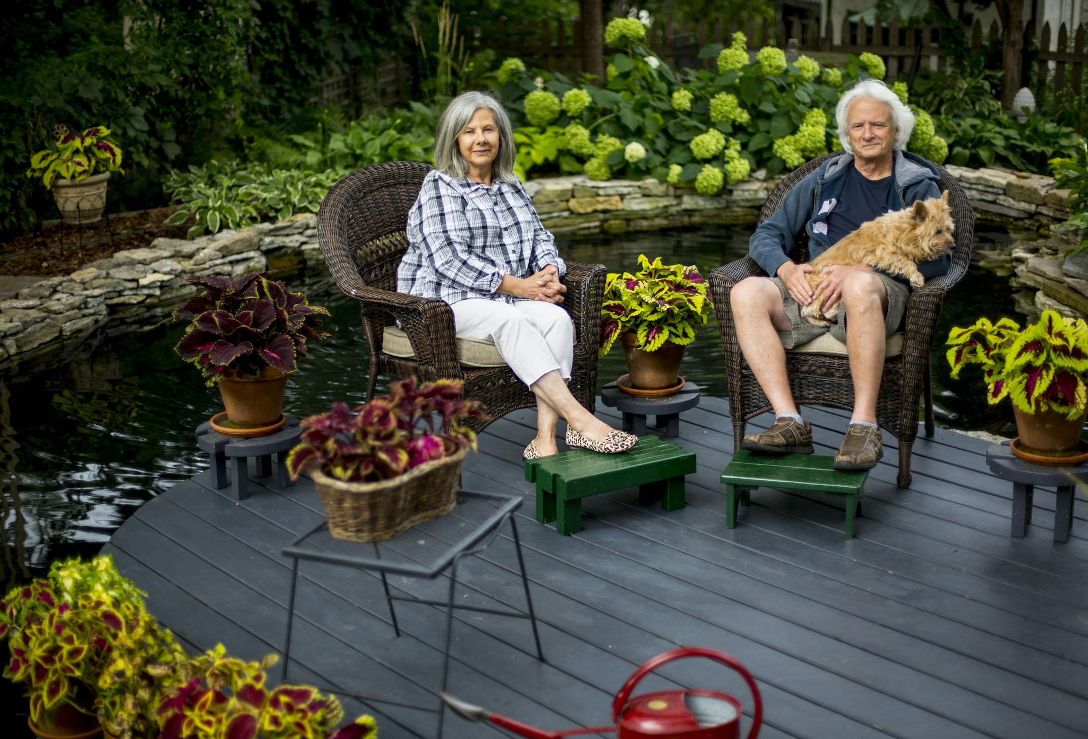 Top Christine Scotillo and Doug Peine, with their dog Gracie, view their backyard beds shaped by limestone walls. Above Concrete lambs accent the outdoor rooms; shade-loving hosta along a brick pathway; easy-to-grow Annabelle hydrangeas.