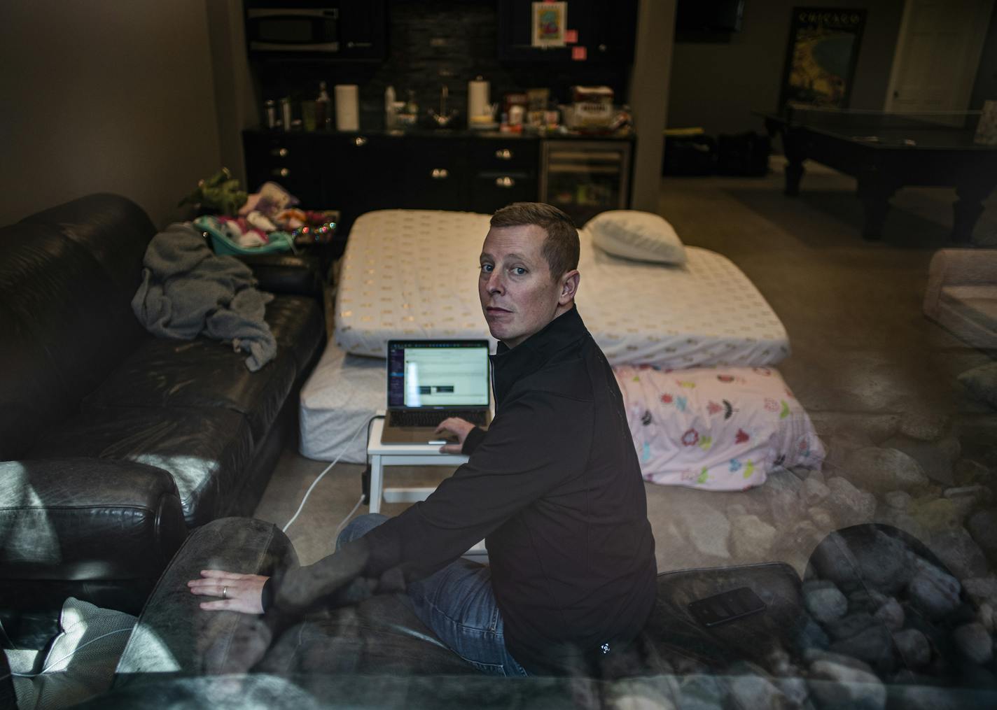 Josh Reiner is isolated from his wife and daughters in the basement of their Edina home as he recovers from a confirmed case of COVID-19.