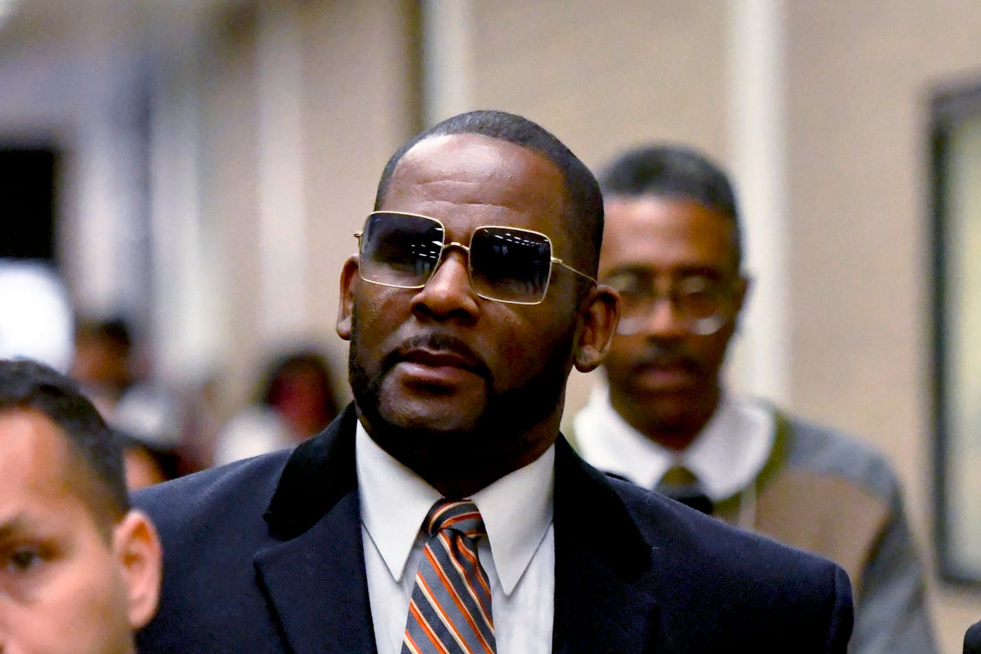 FILE - R. Kelly leaves the Daley Center after a hearing in his child support case May 8, 2019, in Chicago. According to federal officials Monday, April 24, 2023, singer R. Kelly was moved from a Chicago correctional center to a medium-security prison in North Carolina last week. A federal judge in Chicago sentenced the 56-year-old Grammy Award-winning R&amp;B singer in February to 20 years in prison for child pornography and enticement of minors for sex. (AP Photo/Matt Marton, File)