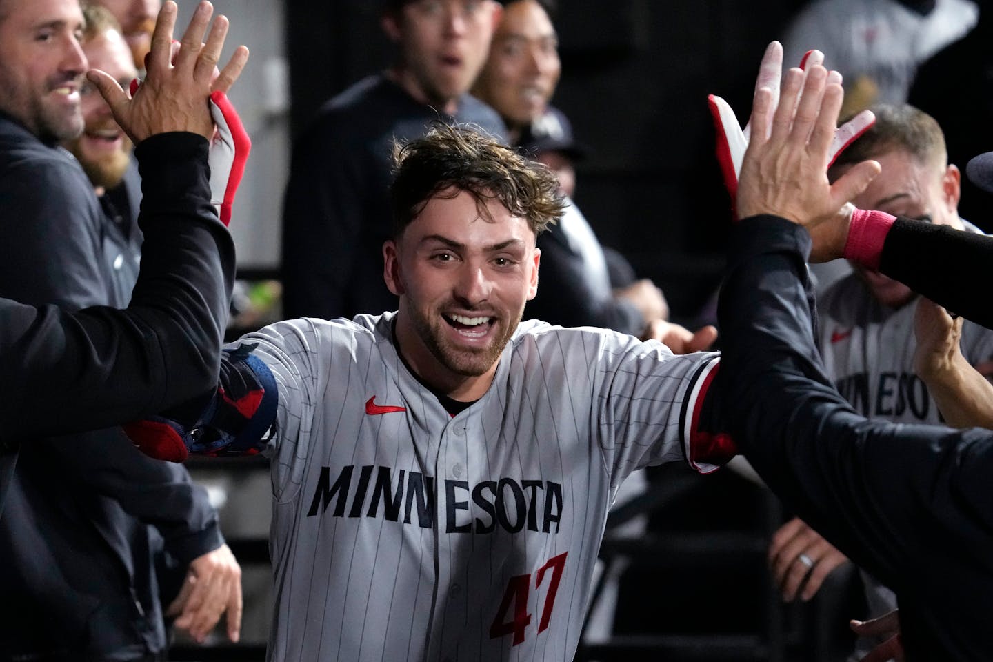 Minnesota Twins' Edouard Julien celebrates with teammates in the dugout after hitting a solo home run against the Chicago White Sox during the fourth inning of a baseball game in Chicago, Thursday, Sept. 14, 2023. (AP Photo/Nam Y. Huh)