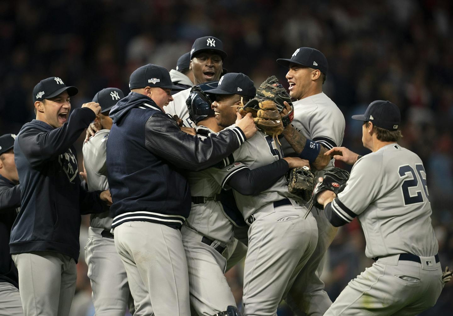 New York Yankees closer Aroldis Chapman (54) was mobbed by teammates after the Yankees defeated the Twins.