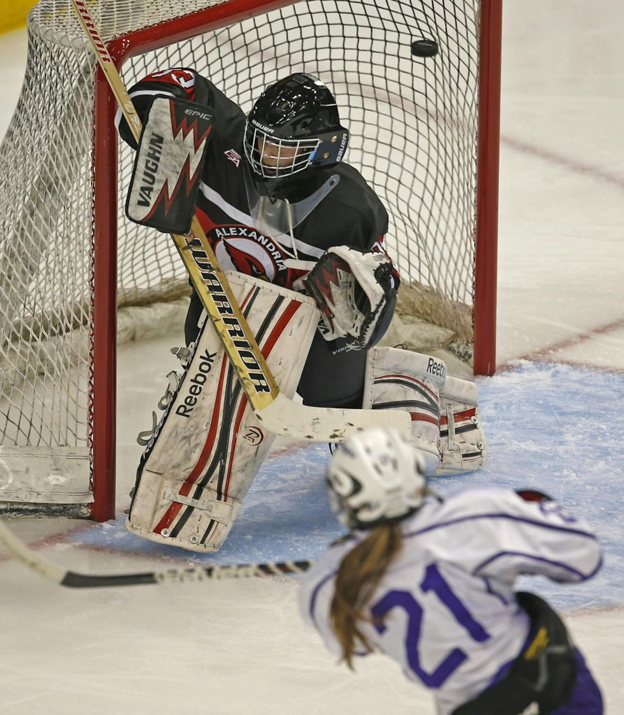 Minnesota State Girls Hockey Tournament Class 2A Quarterfinals, Red Wing vs. Alexandria, 2/20/13. (left to right) Alexandria goalie Amy Jost couldn't stop Red Wing's Nicole Schammel from scoring in second period action. Schammel had four goals through 2 periods of play.