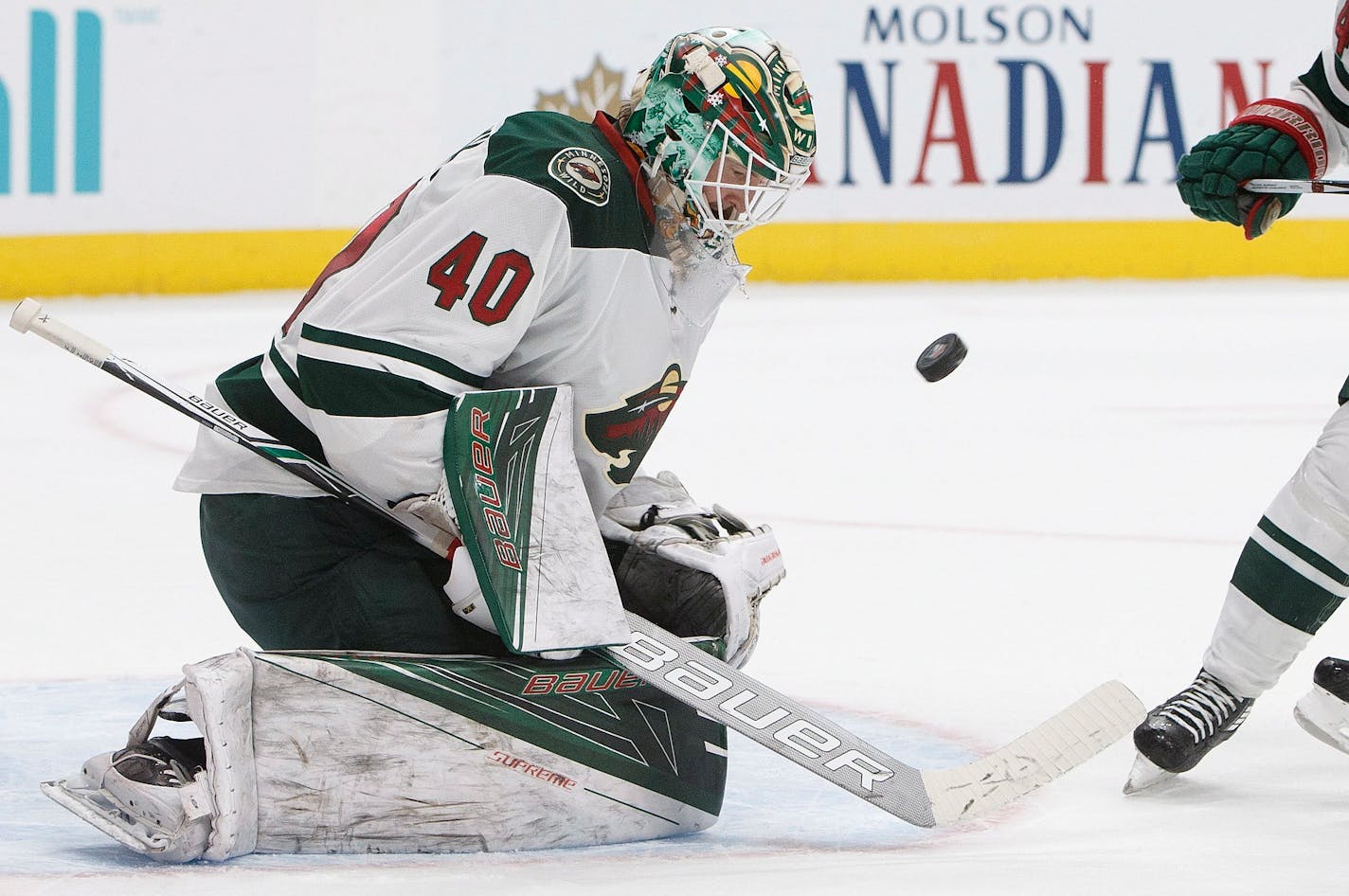 Minnesota Wild goalie Devan Dubnyk (40) makes a save against the Edmonton Oilers during the third period of an NHL hockey game in Edmonton, Alberta, Sunday, Dec. 4, 2016. (Jason Franson/The Canadian Press via AP)