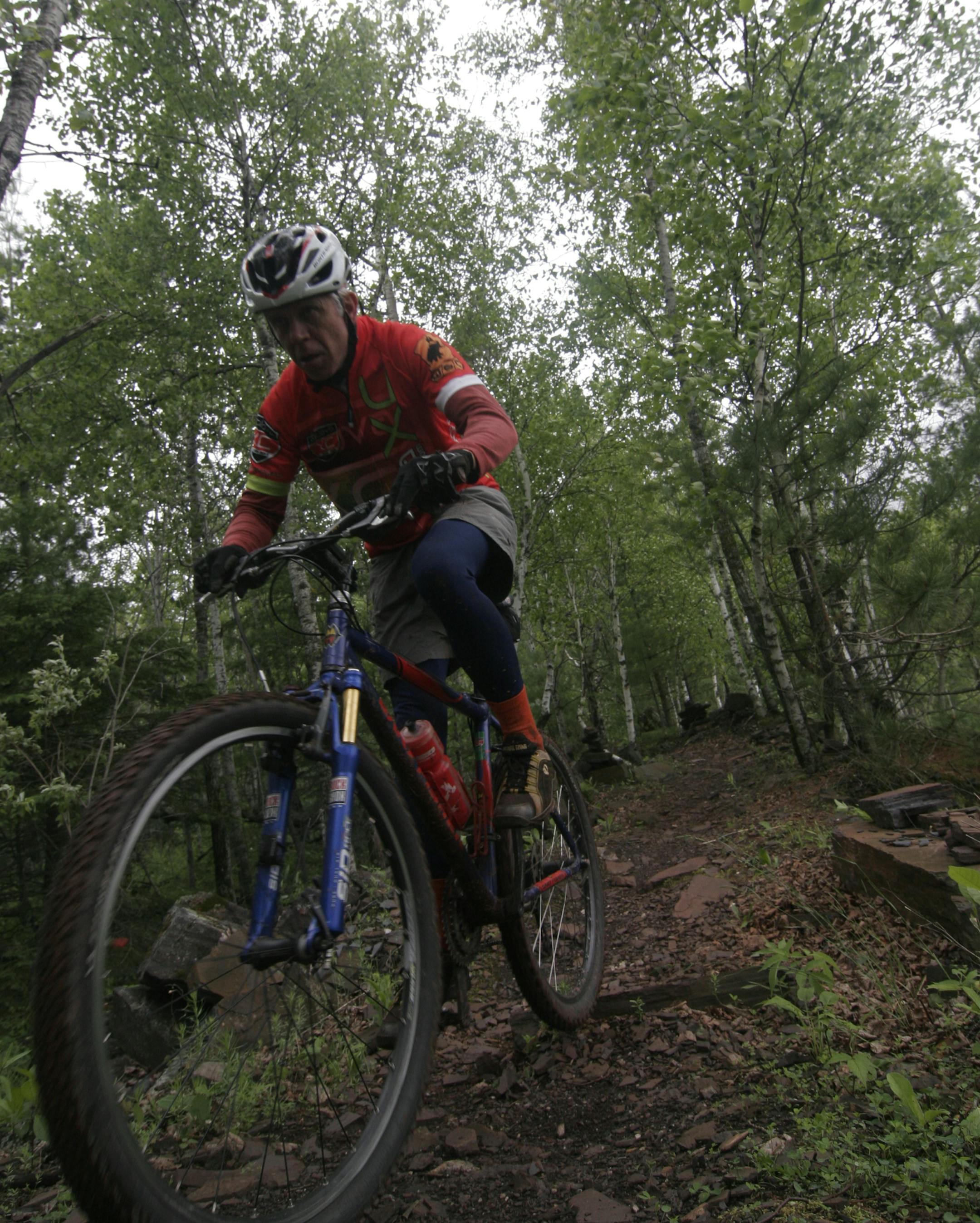Duane Lee of Lindstrom, Minn., navigates a rocky stretch of mountain bike trail at Cuyuna Country State Recreation Area.