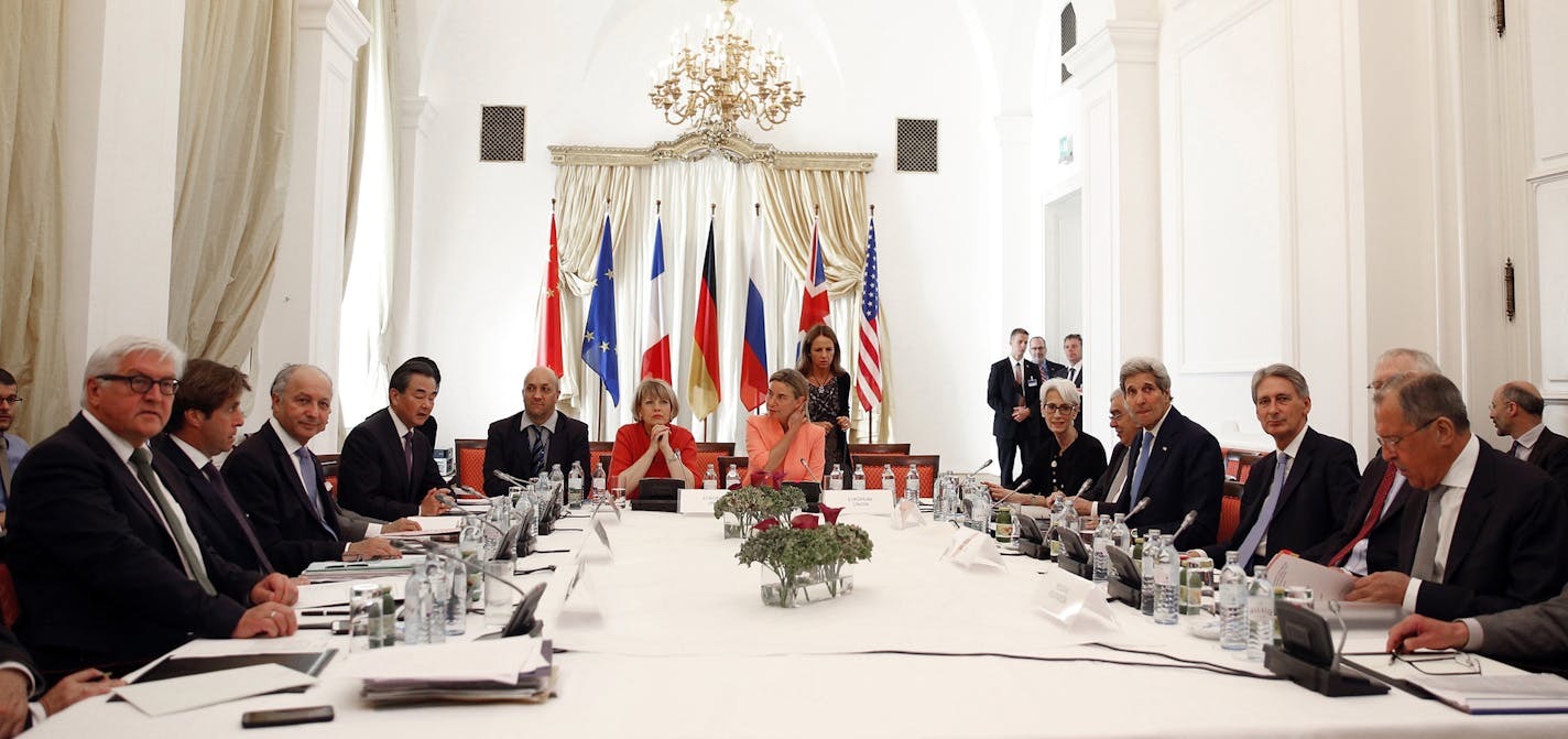 German Foreign Minister Frank-Walter Steinmeier, left, French Foreign Minister Laurent Fabius, 3rd left, Chinese Foreign Minister Wang Yi, 4th left, European Union High Representative for Foreign Affairs and Security Policy Federica Mogherini, centre row, right, U.S. Secretary of State John Kerry, 4th right, British Foreign Secretary Philip Hammond, 3rd right, and Russian Foreign Minister Sergey Lavrov, right, meet at an hotel in Vienna, Austria Monday, July 6, 2015. Iran's foreign minister Moha