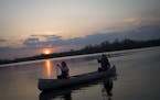 Jessica Krocak and her mother, Ann Krocak, canoe across Cleary Lake at sunset on Friday night. ] (Aaron Lavinsky | StarTribune) aaron.lavinsky@startri