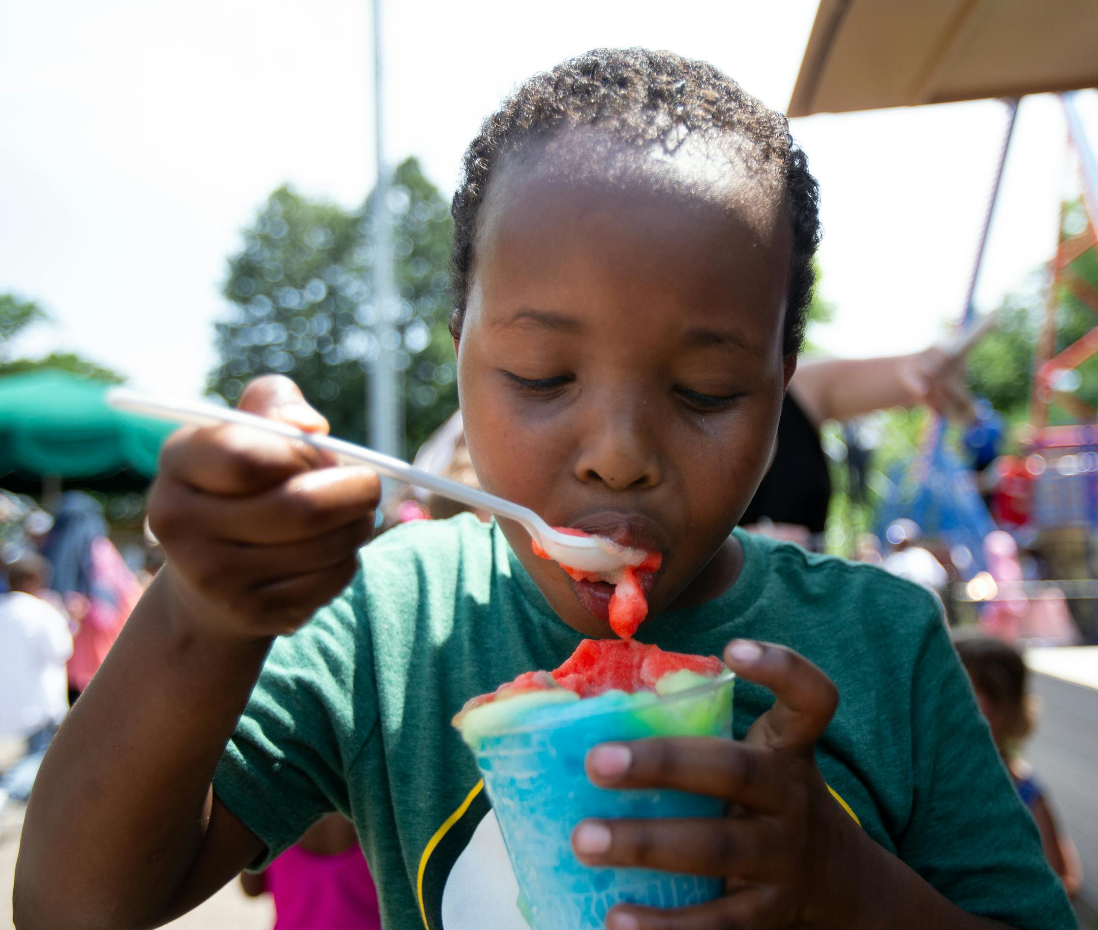 Zekeriye Ibrahim enjoys an Icee on the first day of Eid on Friday in Como Town. ] ALEX KORMANN • alex.kormann@startribune.com Friday, June 15, 2018 is the first day of Eid, the Islamic holiday celebrating the end of Ramadan. After thirty days of fasting, families celebrate by going to their Mosque for prayer in the morning and then spending the day together having fun. Como Park is a popular spot for families with young kids to enjoy the day. There they enjoy the rides, food and zoo anima