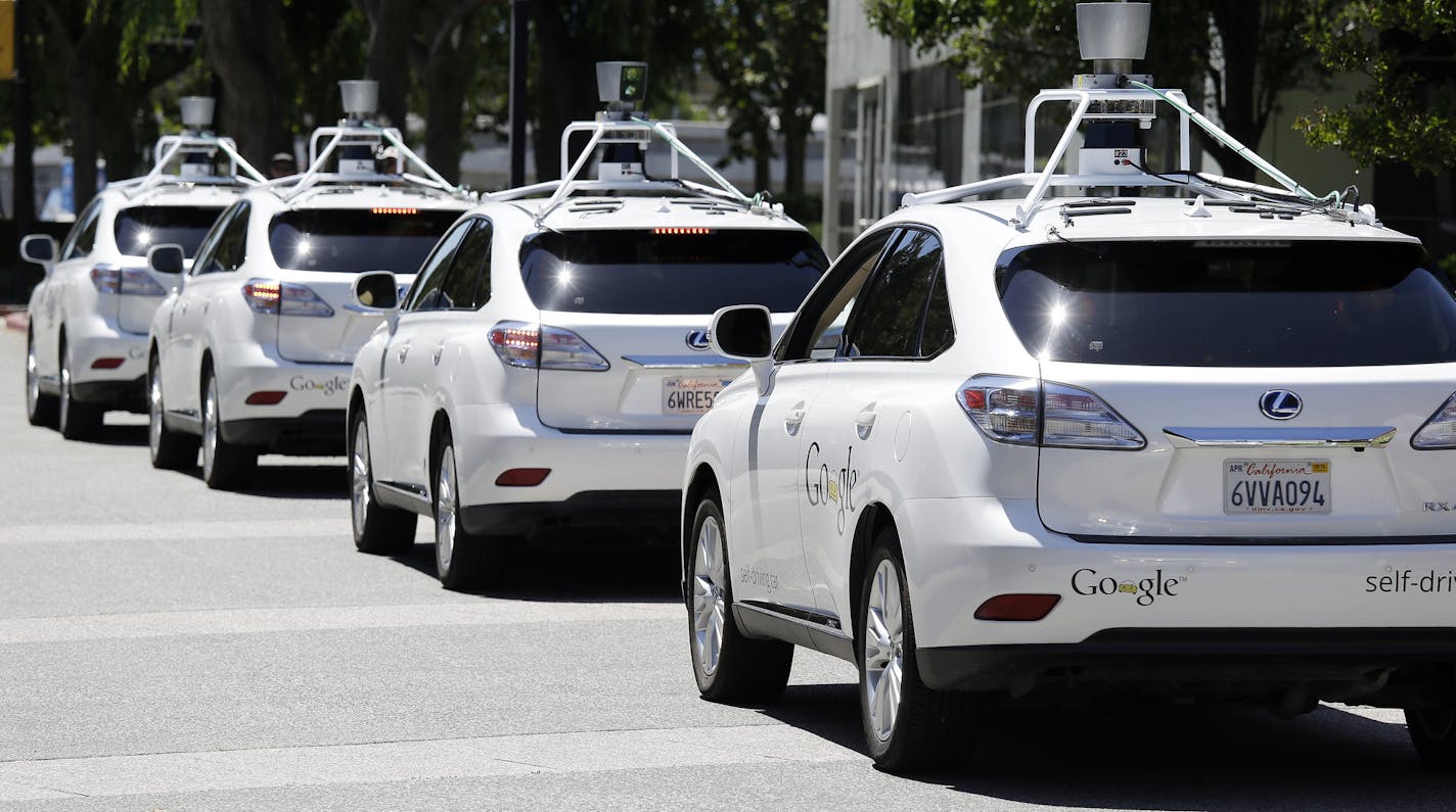 FILE - This May 13, 2014 file photo shows a row of Google self-driving Lexus cars at a Google event outside the Computer History Museum in Mountain View, Calif. Of the nearly 50 self-driving cars rolling around California roads and highways, four have gotten into accidents since September, 2014. That&#xed;s when the state officially began permitting these cars of the future, which use sensors and computing power to maneuver around traffic. Three accidents involved souped-up Lexus SUVs run by Goo