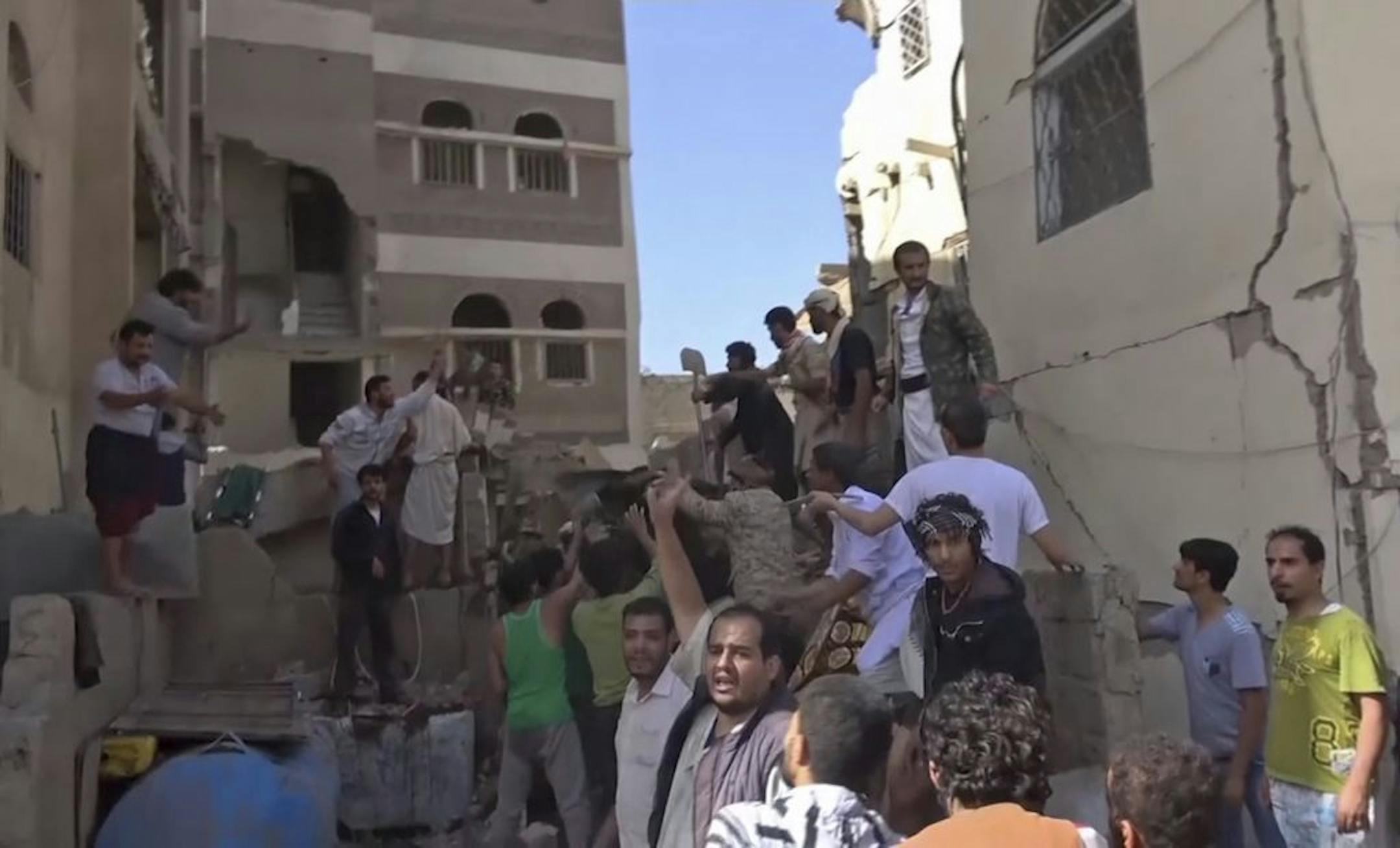 In this frame grab from from video, people search in the rubble following Saudi-led coalition airstrikes that killed at least six, including children, officials said, in the residential center of the capital, Sanaa, Yemen. The Sanaa airstrikes came after Yemen's Iran-backed Houthi rebels, who control the capital, launched a drone attack earlier in the week on a critical oil pipeline in Saudi Arabia, Tehran's biggest rival in the region.