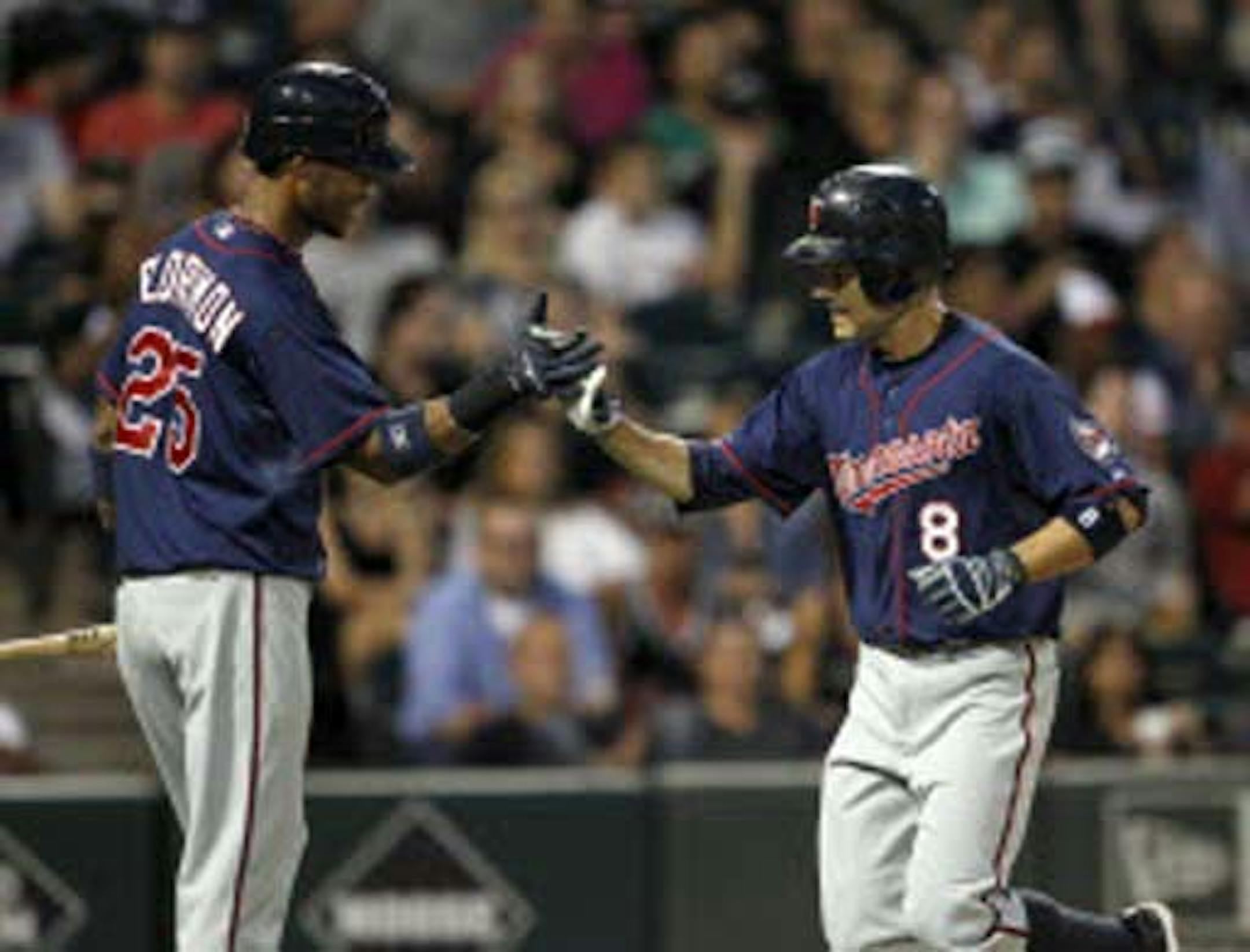 Twins shortstop Pedro Florimon (25) celebrated with second baseman Jamey Carroll after Carroll's solo home run during the fifth inning against the Chicago White Sox on Monday.