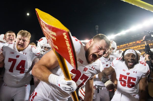 Wisconsin tight end Hayden Rucci (87) chops a goalpost with Paul Bunyan’s Axe after defeating Minnesota 28-14 Saturday, Nov. 25, 2023, at Huntington