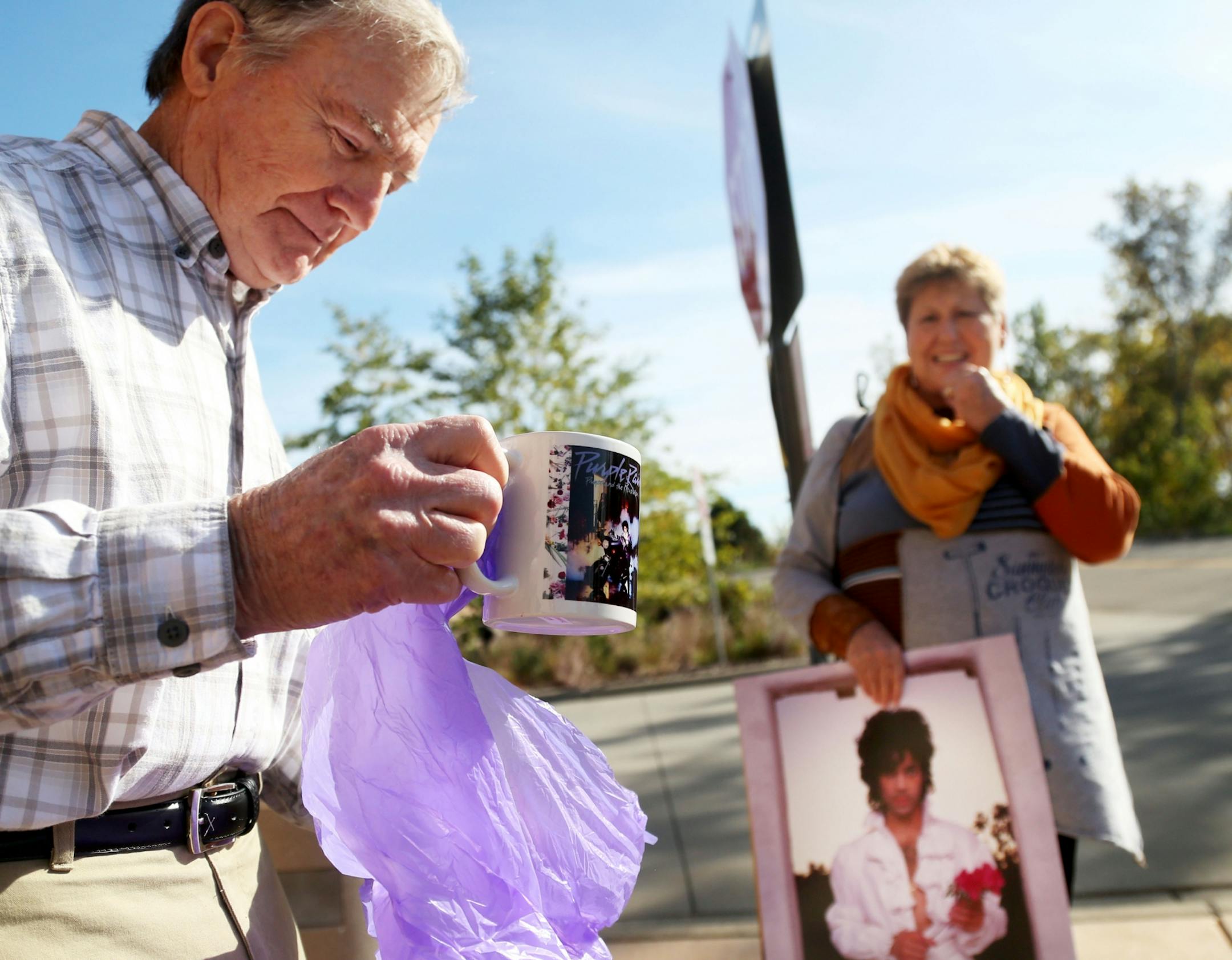 Nordien Jackson, of Red Wing, reveals a Purple Rain coffee cup from his purple bag after he and his wife Phyllis Jackson were among the first to tour Paisley Park and were dropped off by bus at the Southwest Transit Center following the tour Thursday, Oct. 6, 2016, in Chanhassen, MN.
