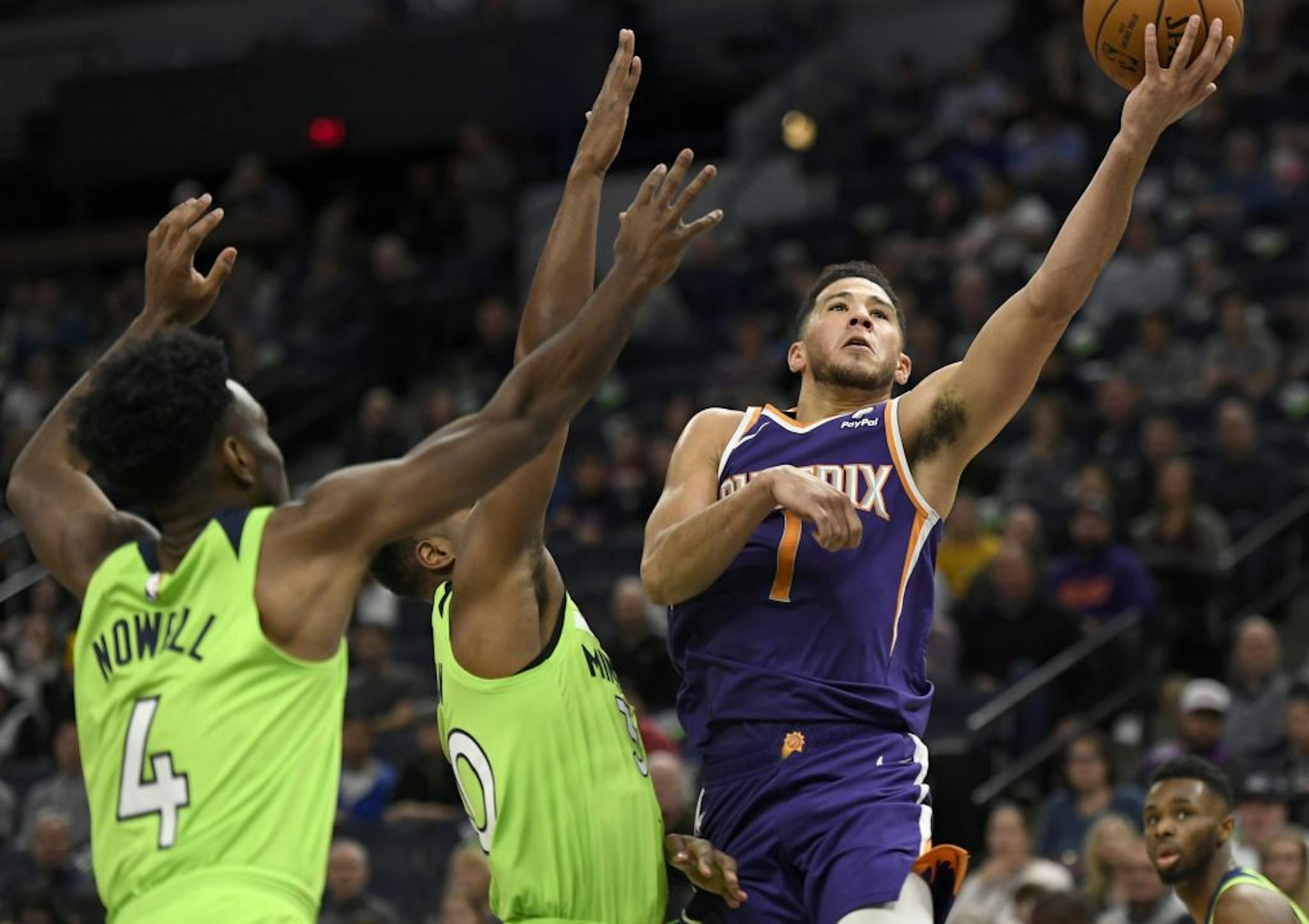 Phoenix Suns guard Devin Booker (1) shoots a layup as Minnesota Timberwolves' Jaylen Nowell (4) and Kelan Martin defend during the first quarter of an NBA basketball game on Saturday, Nov. 23, 2019, in Minneapolis. The Suns won 100-98.