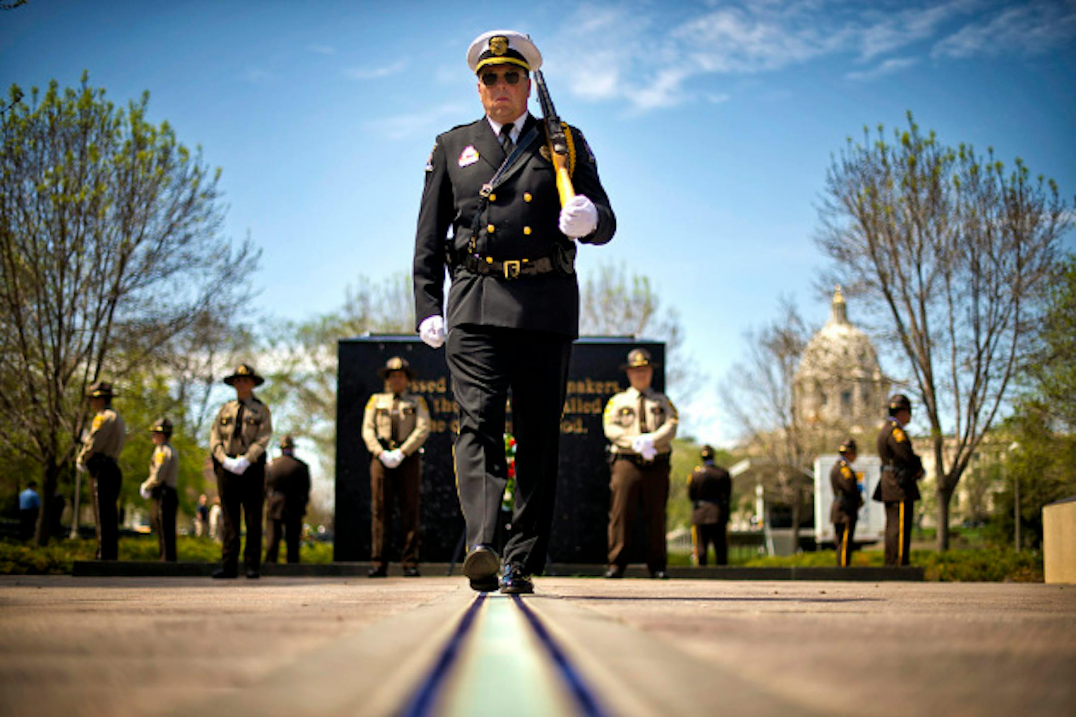 Doug Frericks of the Minnesota Law Enforcement Memorial Association walked the thin blue line of the Peace Officers Memorial at the Minnesota State Capitol as part of National Law Enforcement Memorial Day.  Between 300-400 officers from 75 organizations honored the 270 officers killed in the line of duty since 1874.  ]   GLEN STUBBE * gstubbe@startribune.com