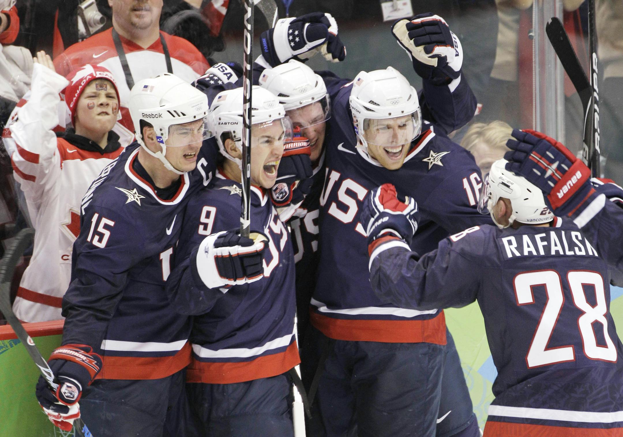 USA's Jamie Langenbrunner (15), Zach Parise (9), Ryan Suter (20), Erik Johnson (6), and Brian Rafalski (28) celebrate after Parise scored against Canada in the third period of the men's gold medal ice hockey game at the Vancouver 2010 Olympics in Vancouver, British Columbia, Sunday, Feb. 28, 2010. (AP Photo/Mark Humphrey) ORG XMIT: OLYMH208