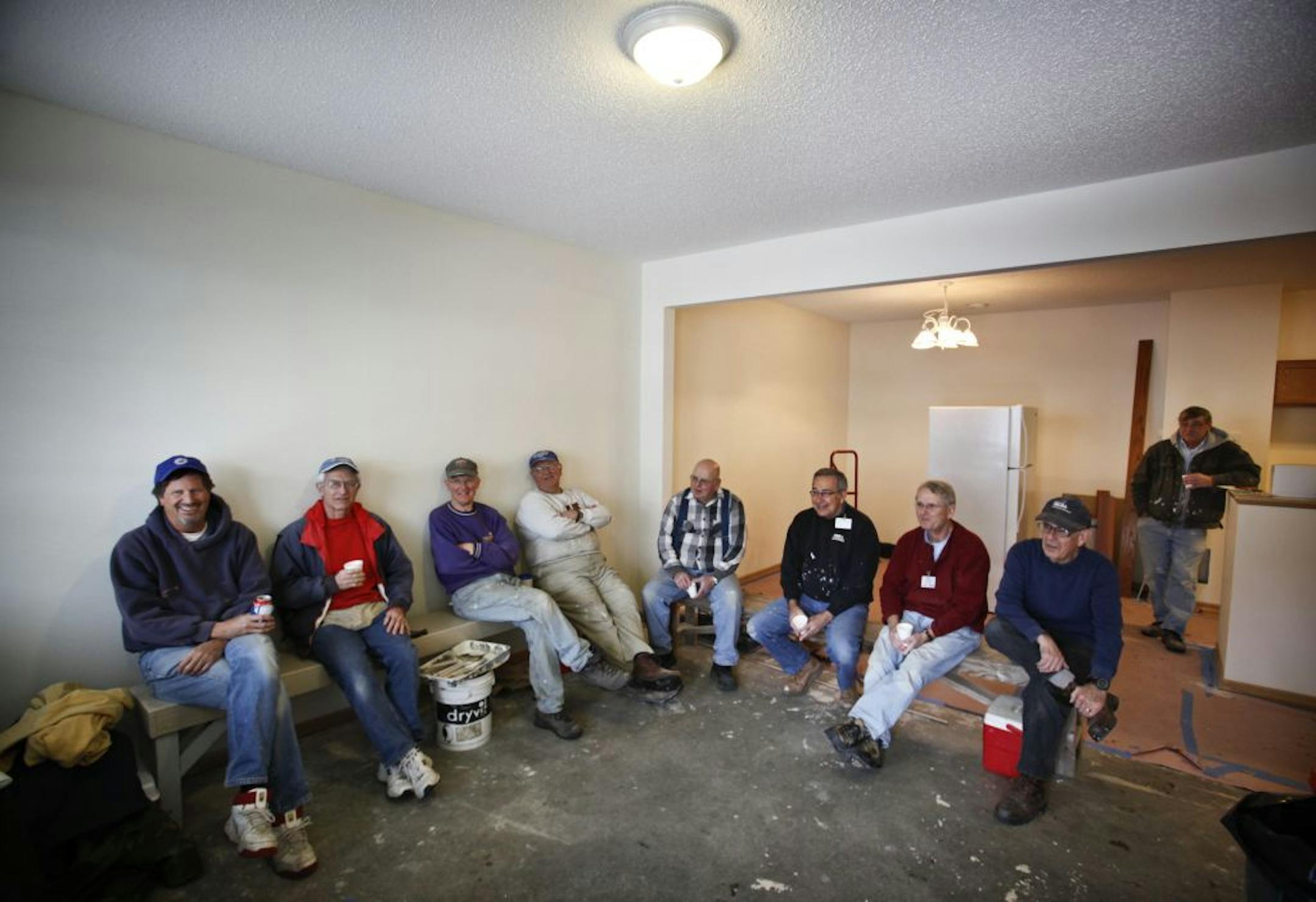 The Habitat crew at Garden Gate development break for coffee and donuts Tuesday, Feb. 21, 2012, in Woodbury, MN. Many of the crew are retired 3M workers, including Dick Kasel, who's been offering his services to Habitat for 16 years. "It keeps me young," said Kasel, fourth from left.
