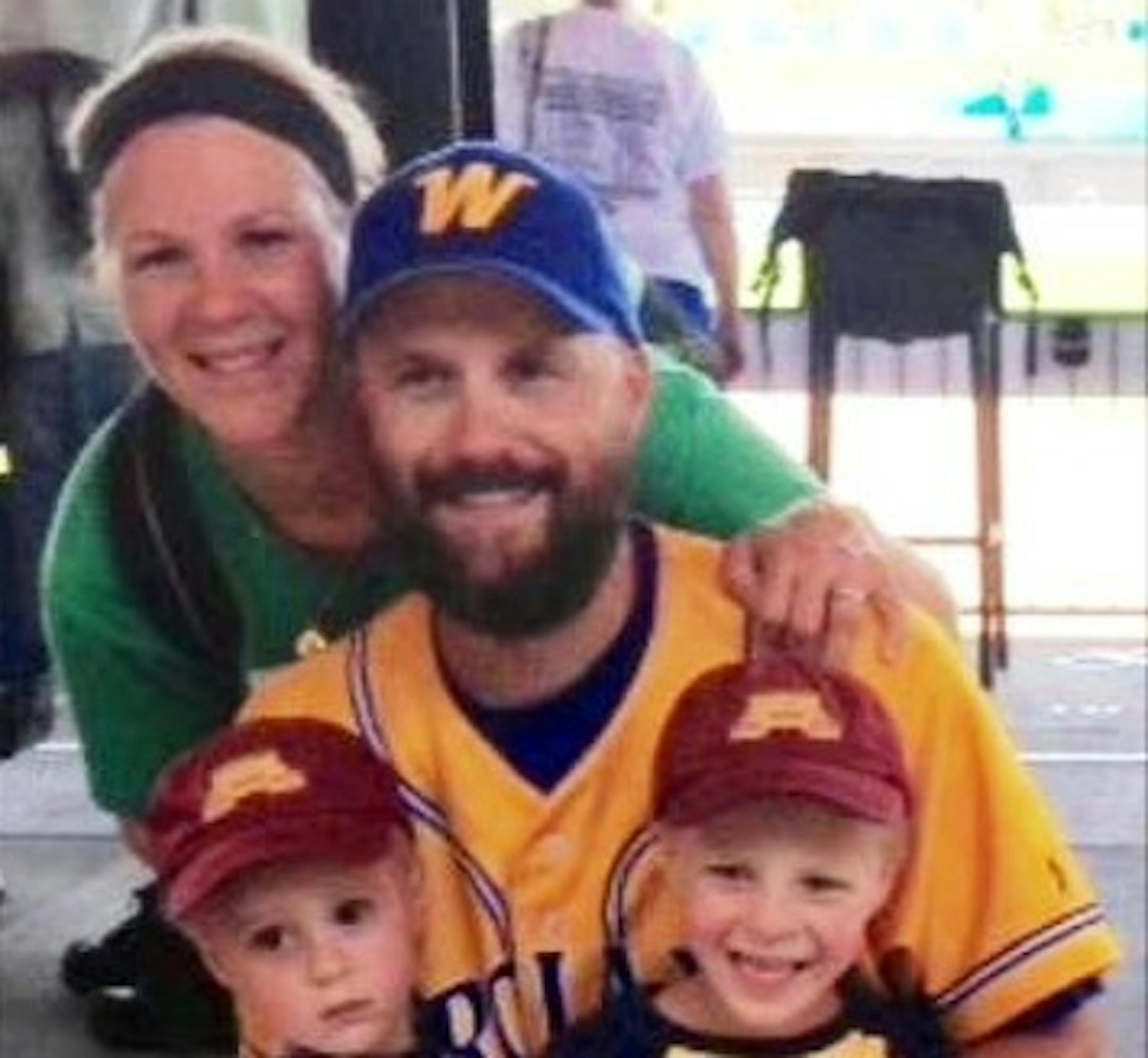 Wayzata coach Bobby DeWitt with his wife, Rachel, and sons William (left) and Sam following the Trojans' 4-2 victory over Lakeville North in the Class 4A baseball semifinals.