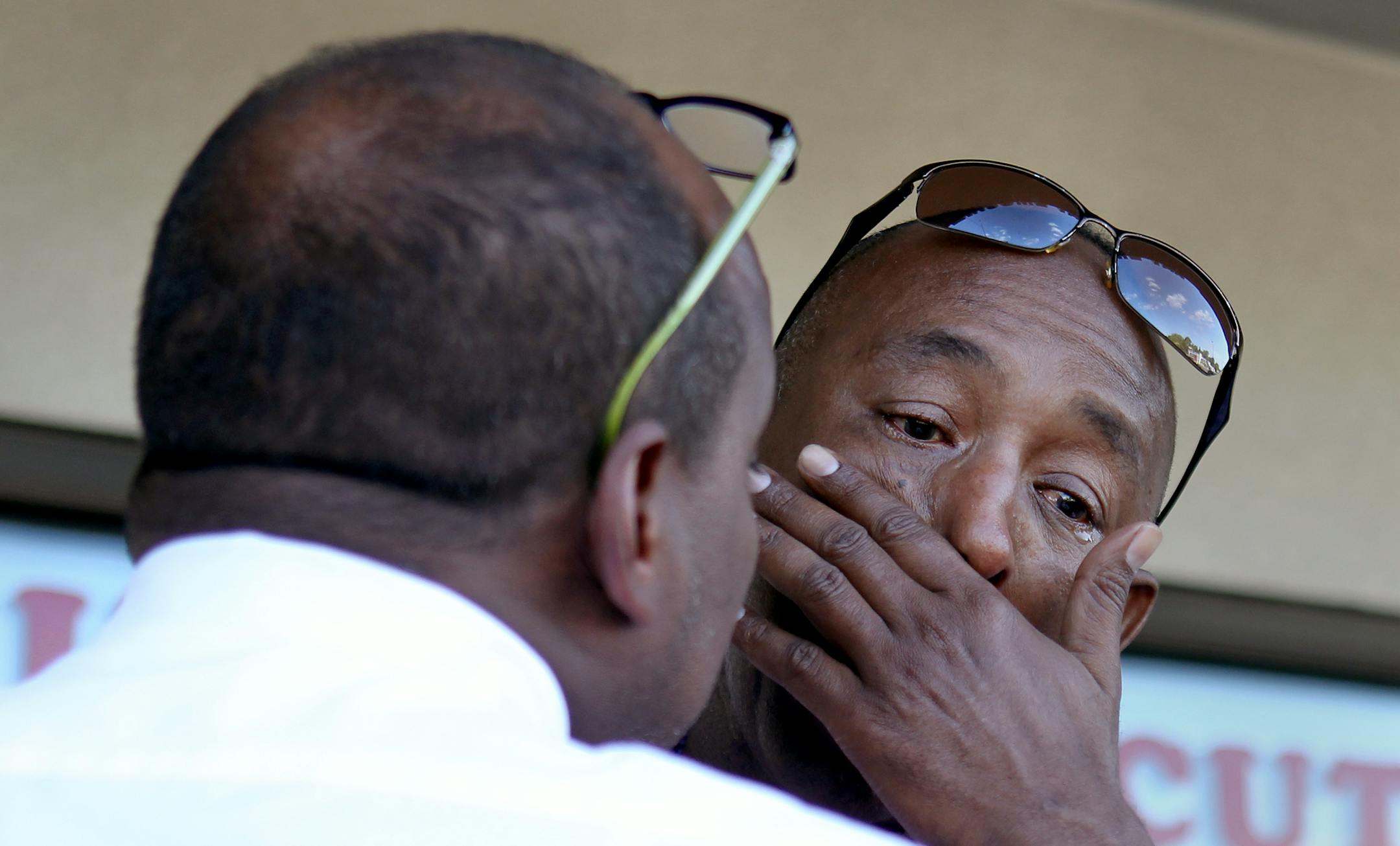 Mohamed Guled Abdi, facing, of St. Paul, reflects on the life of his son while hugging Somali activist Omar Jamal in Columbia Heights, Minn., on Saturday, August 17, 2013. ] (ANNA REED/STAR TRIBUNE) anna.reed@startribune.com (cq) ORG XMIT: MIN1308171823283830