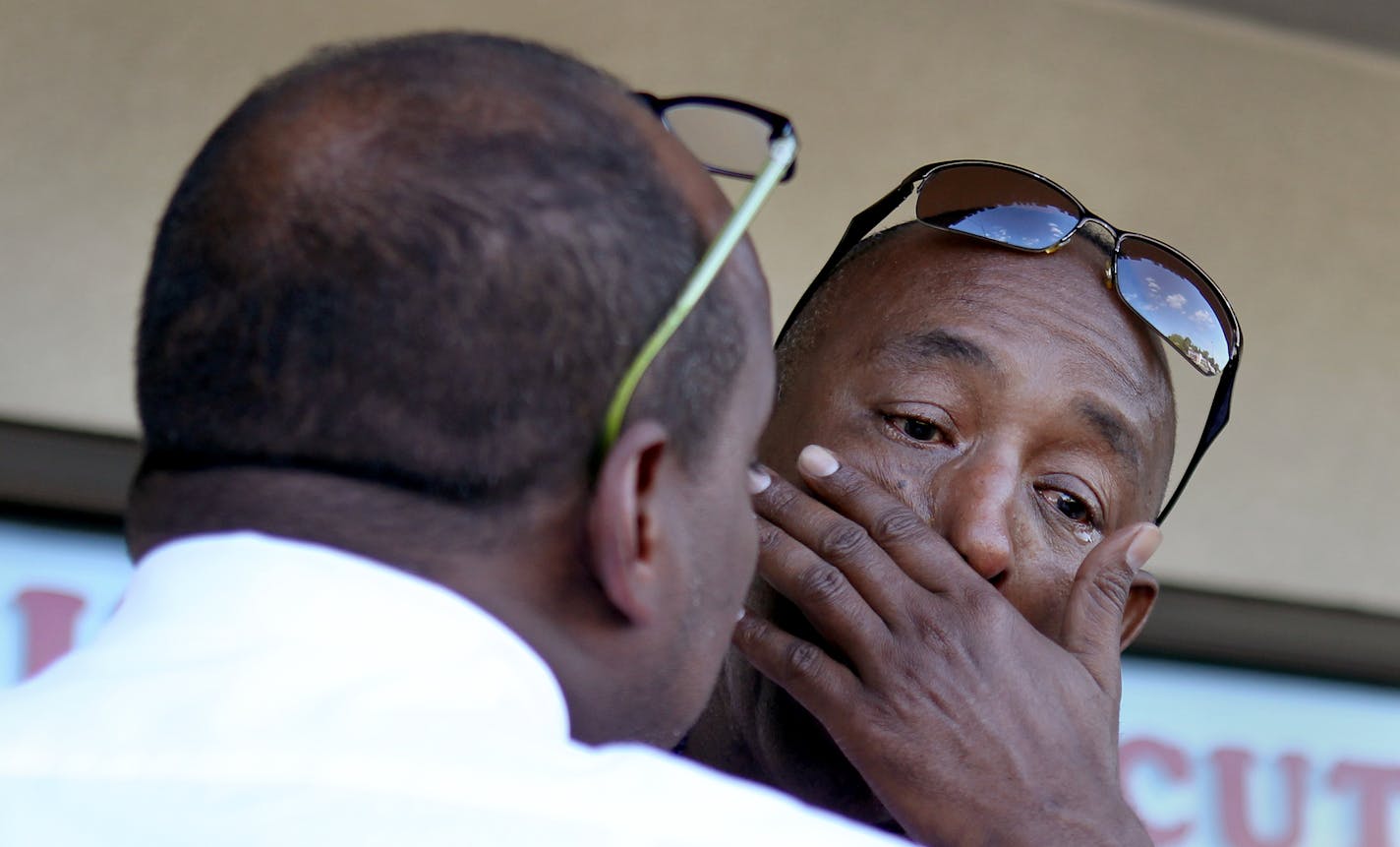 Mohamed Guled Abdi, facing, of St. Paul, reflects on the life of his son while hugging Somali activist Omar Jamal in Columbia Heights, Minn., on Saturday, August 17, 2013. ] (ANNA REED/STAR TRIBUNE) anna.reed@startribune.com (cq) ORG XMIT: MIN1308171823283830