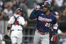 Minnesota Twins' Byron Buxton (25) celebrates while looking at teammates in the dugout after hitting a two-run home run during the fifth inning of a b