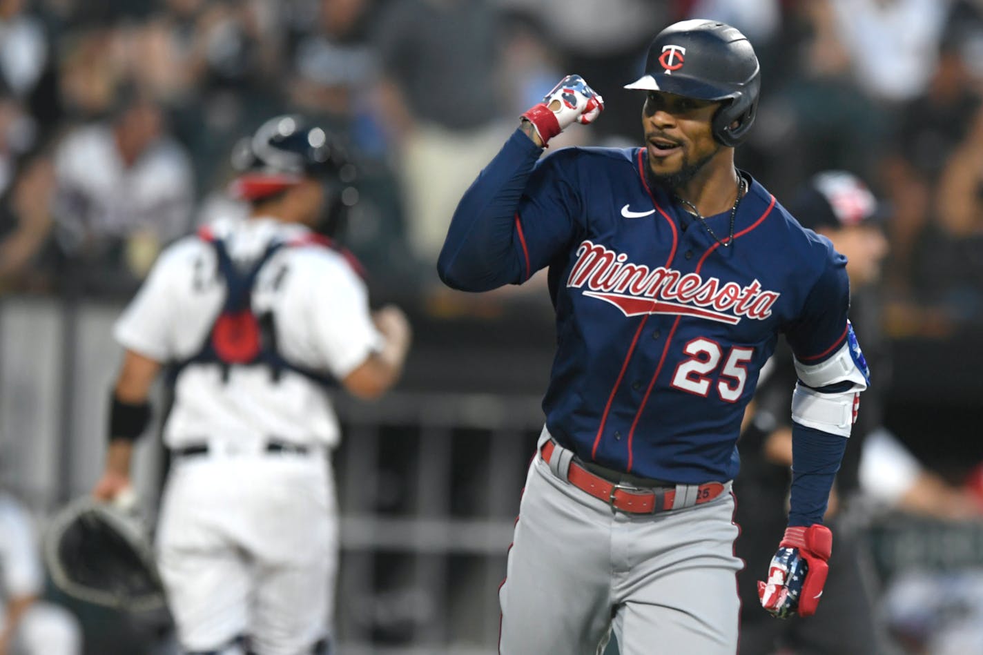 Minnesota Twins' Byron Buxton (25) celebrates while looking at teammates in the dugout after hitting a two-run home run during the fifth inning of a baseball game against the Chicago White Sox Monday, July 4, 2022, in Chicago. (AP Photo/Paul Beaty)