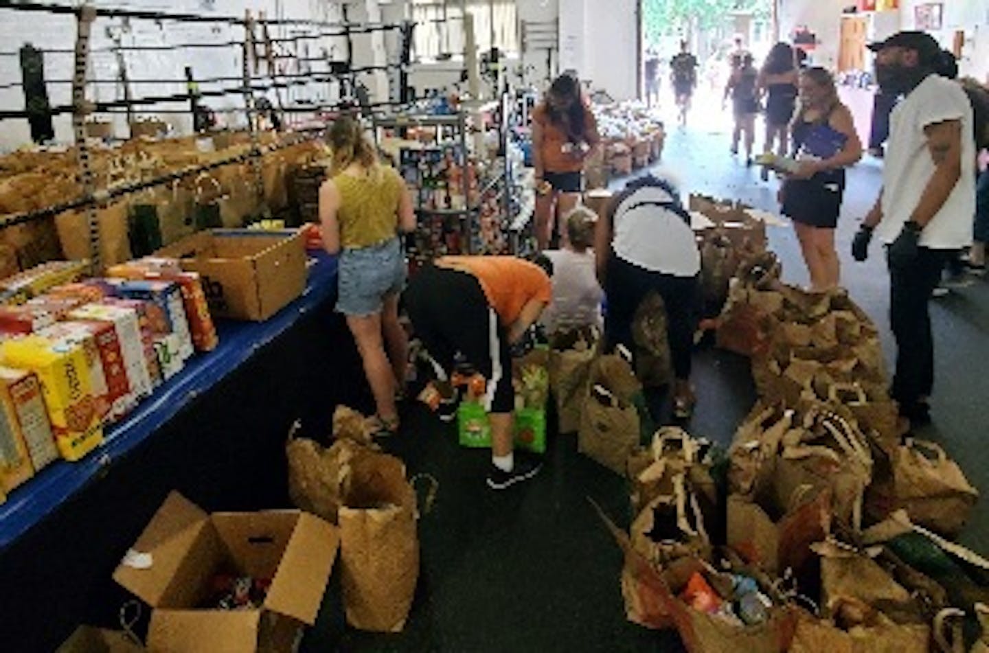 Boxer Jamal James oversaw the packing of supply bags by volunteers at the Circle of Discipline boxing gym, which became a temporary food shelf after nearby stores were damaged during protests.