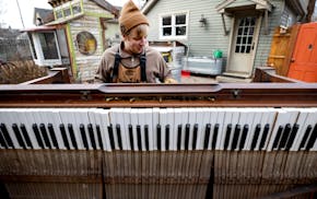 Nate Otto disassembles a player piano in his backyard on Dec. 19 in Anoka.