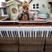 Nate Otto disassembles a player piano in his backyard on Dec. 19 in Anoka.