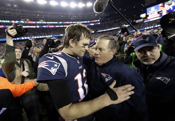 New England Patriots quarterback Tom Brady, left, hugs coach Bill Belichick after last year's AFC championship game against the Jaguars.