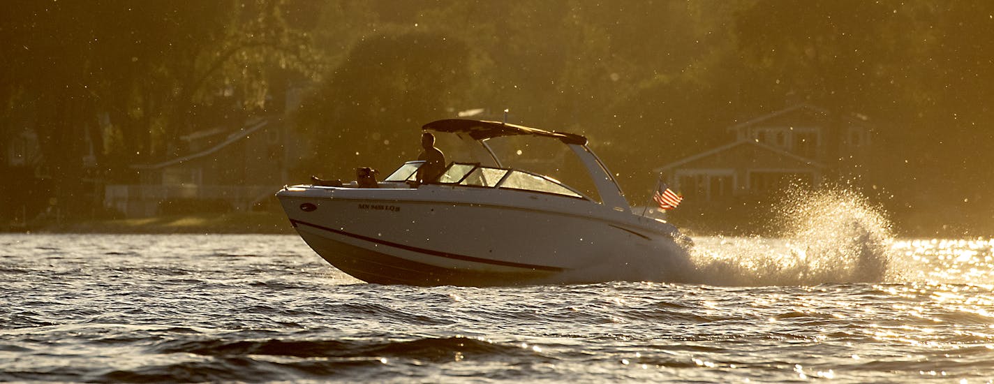 Boaters took to the water as the sun set on Lake Minnetonka Tuesday, July 2, 2019 in Excelsior, MN. The state began charging higher boater registration fees this week to bring back a popular grant program for local lake associations to fight invasive species. ] ELIZABETH FLORES &#x2022; liz.flores@startribune.com