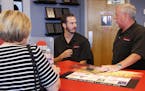 In this July 10, 2018, photo, Greg Goodman, right, and his son Chandler Goodman, center, help a customer at the counter, in their Alta Mere franchise 