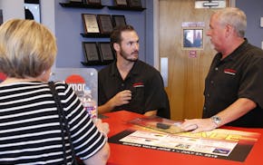 In this July 10, 2018, photo, Greg Goodman, right, and his son Chandler Goodman, center, help a customer at the counter, in their Alta Mere franchise 