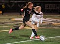 Stillwater Area midfielder Catherine Fredkove (17) runs with the ball as Lakeville North defender Hannah Slaikeu (15) guards in the second half. Still