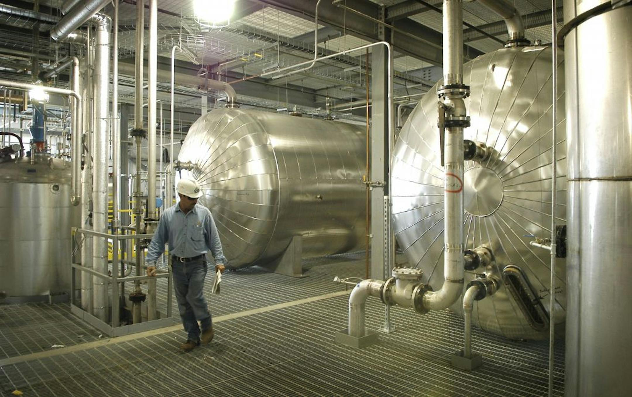A plant worker inspects the tanks used to separate glycerin from biodiesel.