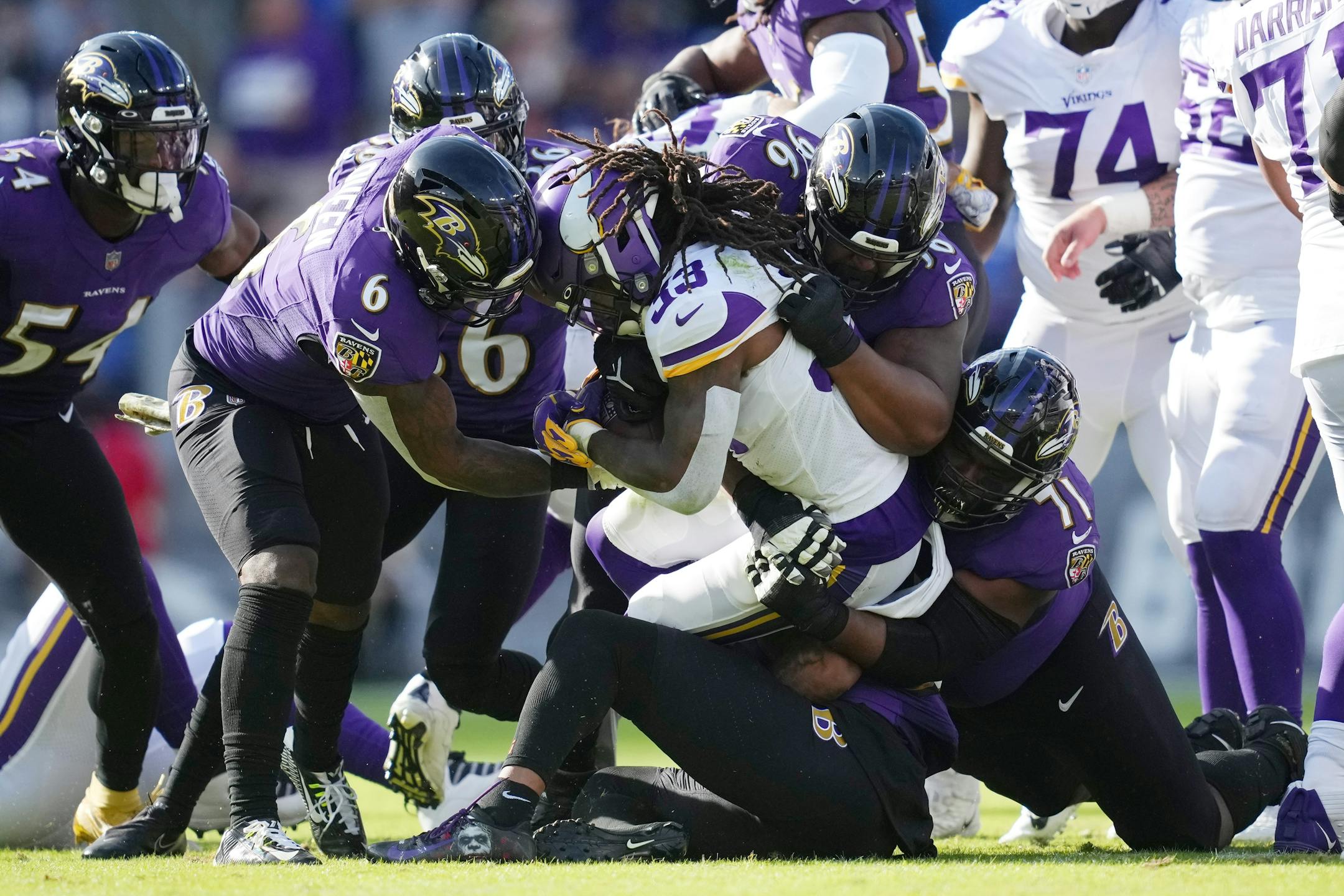 Vikings running back Dalvin Cook (33) was brought down by the Ravens defense in the second quarter.