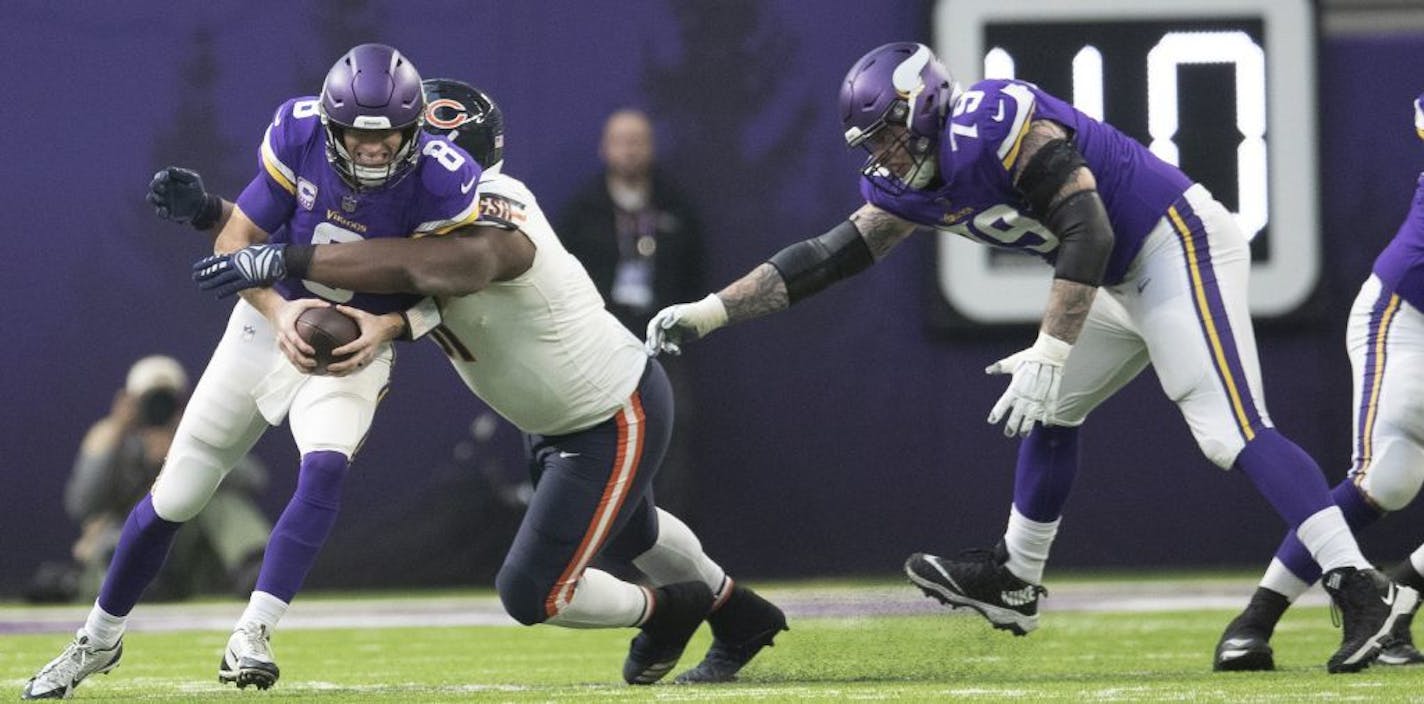 Minnesota Vikings quarterback Kirk Cousins (8) was sacked for 6-yard loss by Chicago Bears nose tackle Eddie Goldman (91) in the first quarter at U.S. Bank Stadium Sunday December 30, 2018 in Minneapolis , MN.