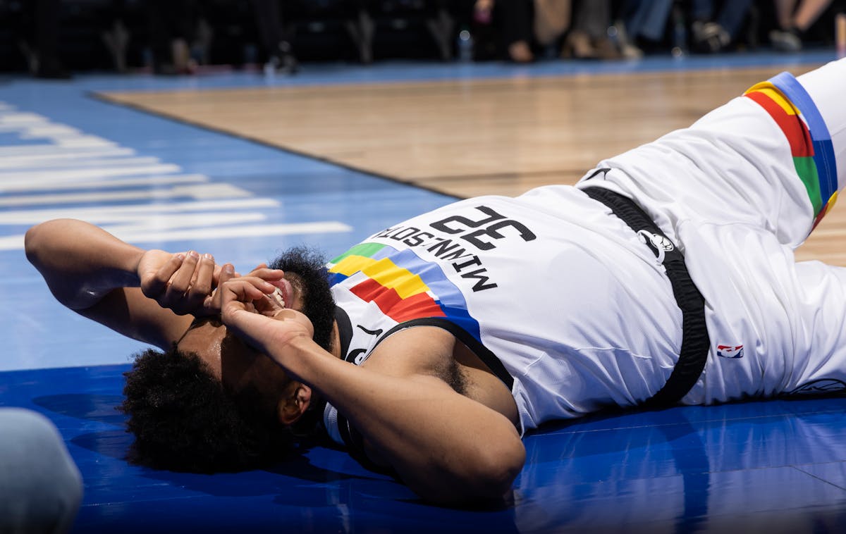 Karl Anthony-Towns of the Minnesota Timberwolves reacts on the floor after being fouled in the first quarter.
