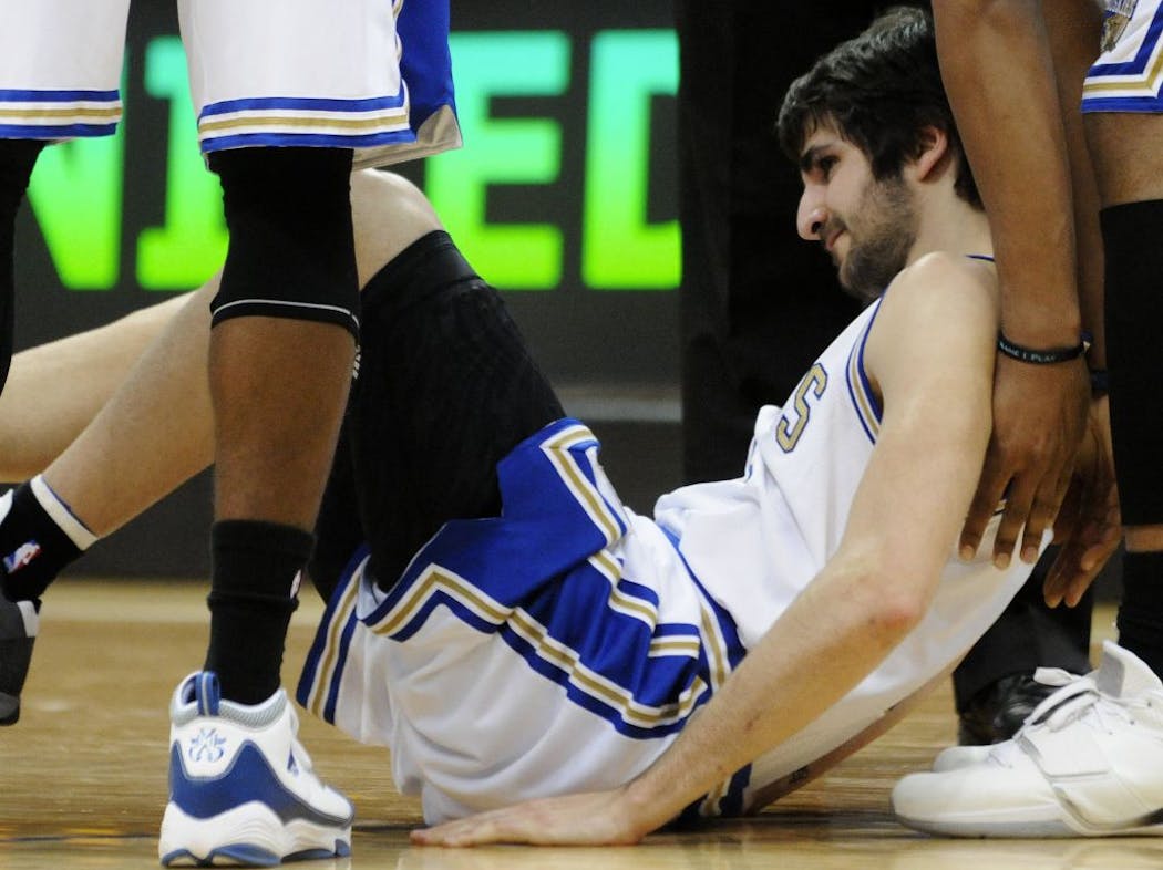 Ricky Rubio, of Spain, is helped up after he went down in a collision with Los Angeles Lakers' Kobe Bryant. Rubio tore his ACL in this collision during his rookie season.