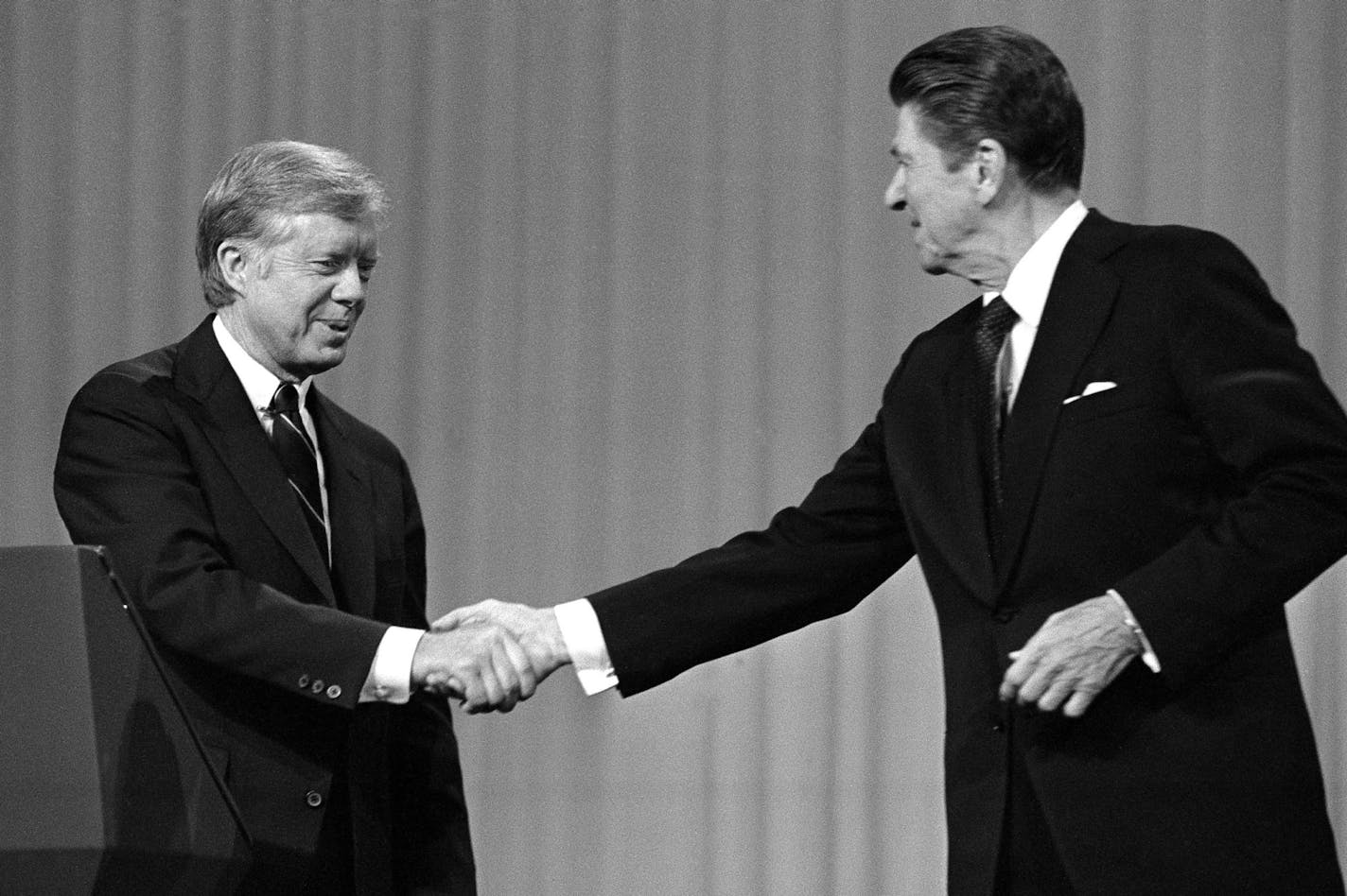 President Jimmy Carter, left, and Republican Presidential candidate Ronald Reagan shake hands after debating in the Cleveland Music Hall on Oct. 28, 1980. They are shown on the Music Hall stage. (AP Photo/Madeline Drexler) ORG XMIT: APHS358644