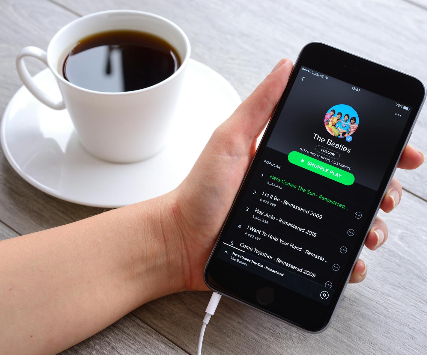 Istanbul, Turkey - January 16, 2016: Woman hands holding an Apple iPhone 6 Plus displaying Spotify application. iPhone, produced by Apple Computer, Inc.