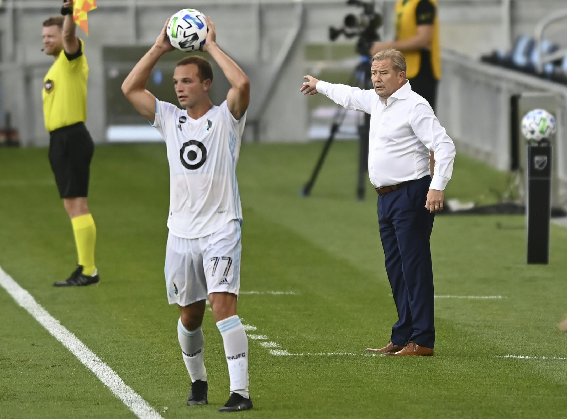 Minnesota United coach Adrian Heath gave his players direction in the first half of last week's game against Sporting Kansas City as defender Chase Gasper (77) threw the ball in bounds.