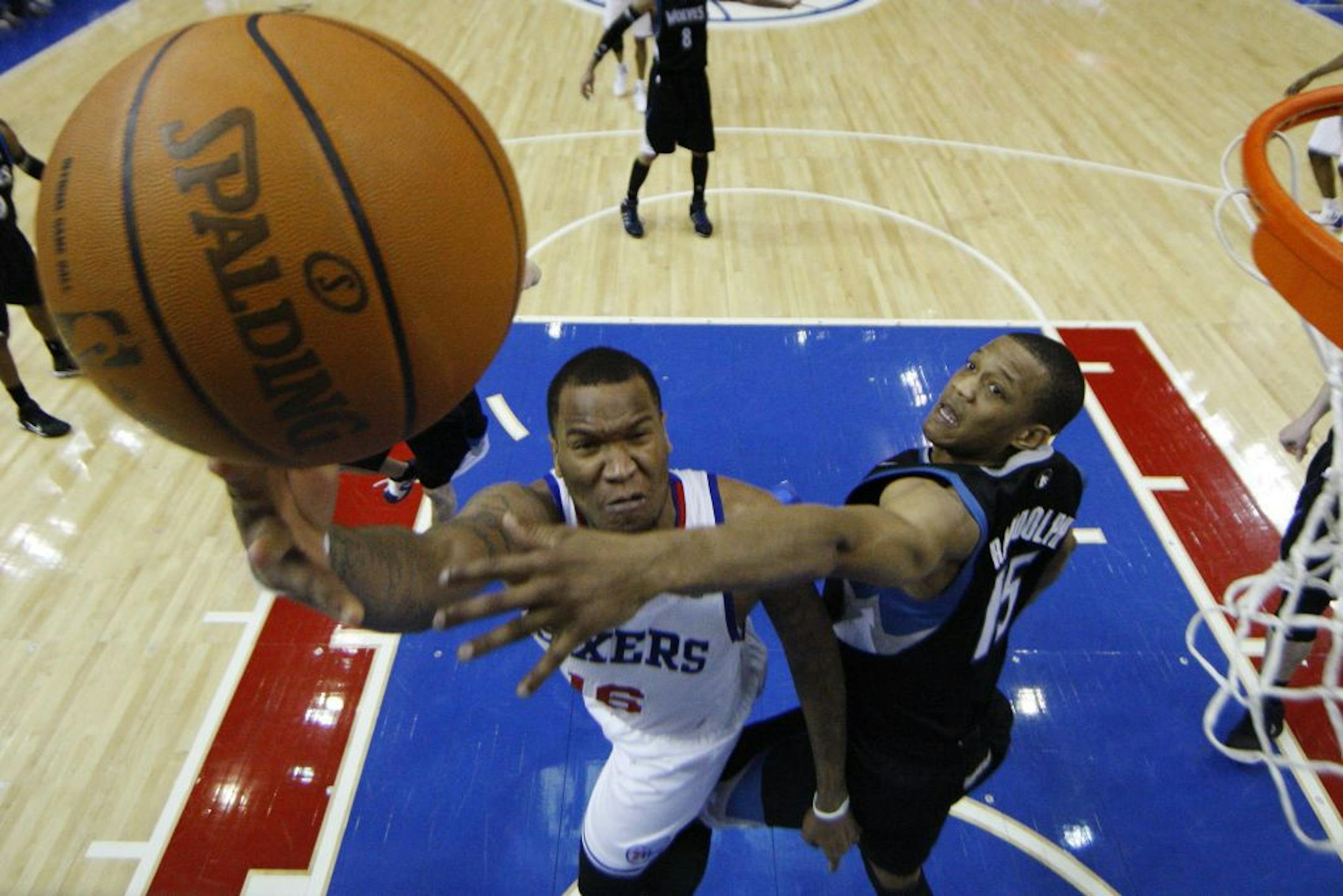 Philadelphia 76ers' Marreese Speights, left, goes up for a shot as Minnesota Timberwolves' Anthony Randolph defends in the second half of an NBA basketball game on Friday, March 4, 2011, in Philadelphia. Philadelphia won 111-100.