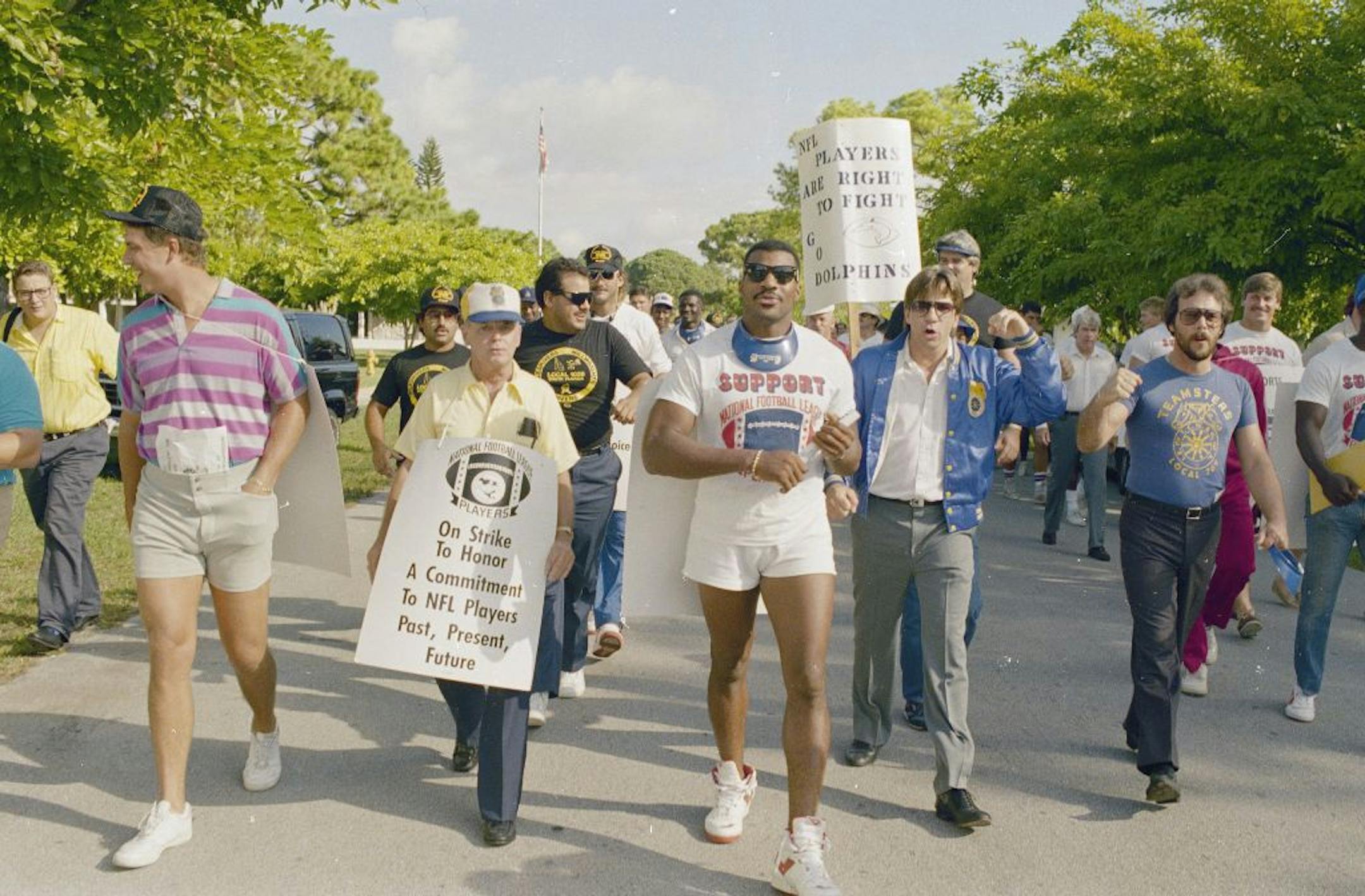 Dan Marino, left, and members of the striking Miami Dolphins, accompanied by supporters, stormed past police at the team's training camp for replacement players in 1987. "You name it and we saw it during the strike games," said Jerry Glanville, coach of the Houston Oilers that year.