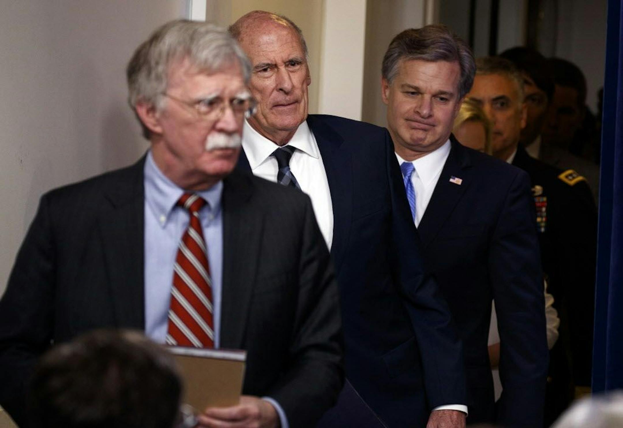 Top national security officials arrive for the daily press briefing at the White House to explain efforts to prevent interference in U.S. elections.