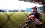 Minnesota Twins catcher Dan Rohlfing sat in the bullpen while waiting for his chance to catch at Twins camp.