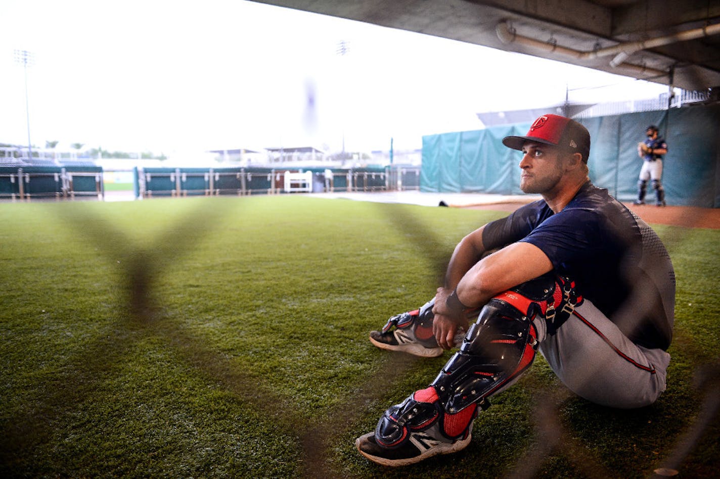 Minnesota Twins catcher Dan Rohlfing sat in the bullpen while waiting for his chance to catch at Twins camp.