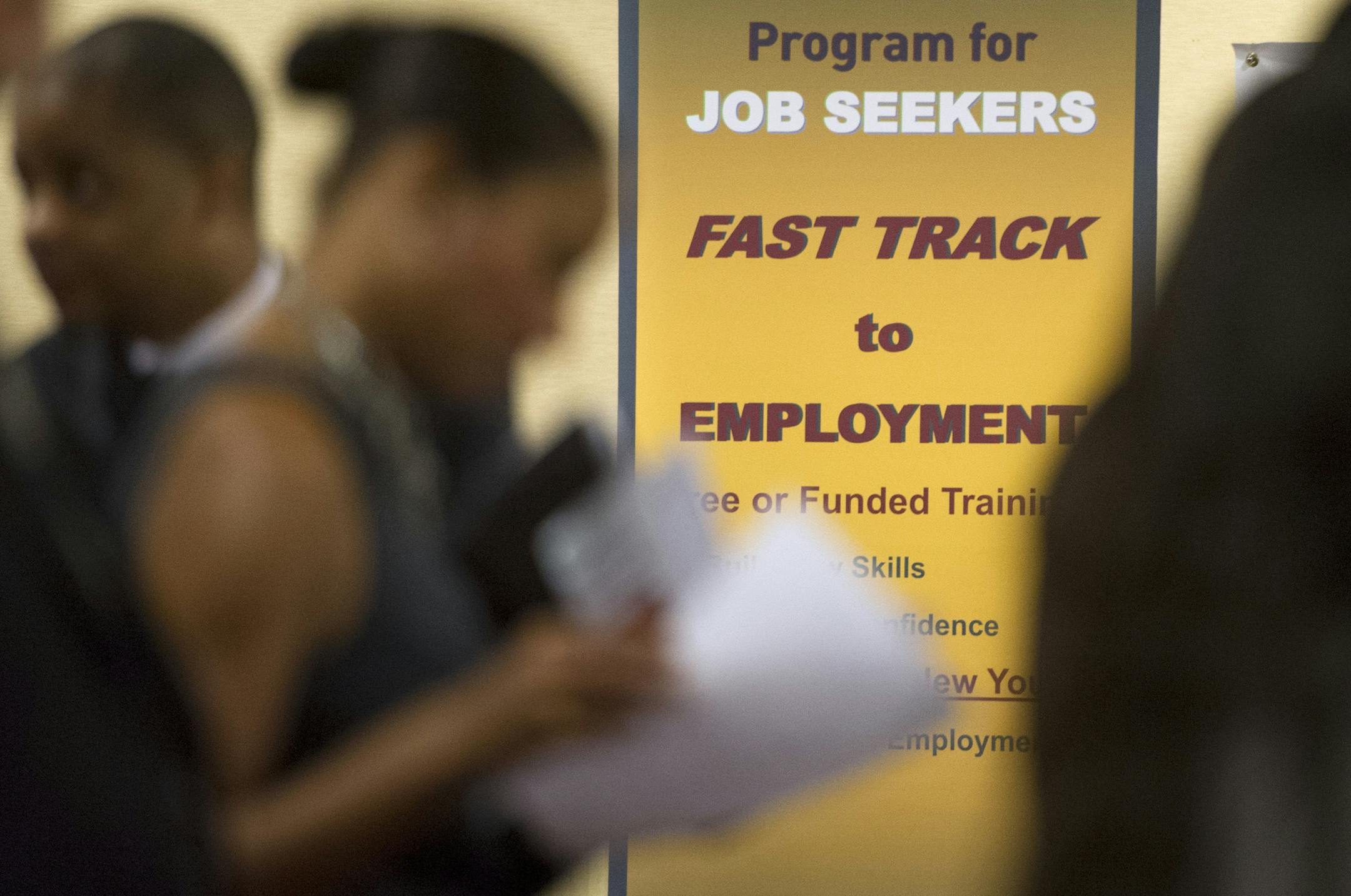 FILE - In this May 30, 2013, photo, job seekers line up to talk to recruiters during a job fair held in Atlanta. The number of people seeking U.S. unemployment benefits dropped 12,000 to a seasonally adjusted 350,000 last week, though the total was elevated for the third straight week by technical problems in California. The Labor Department said Thursday, Oct. 24, 2013, that the less volatile four-week average jumped by nearly 11,000 to 348,250. (AP Photo/John Amis, file)