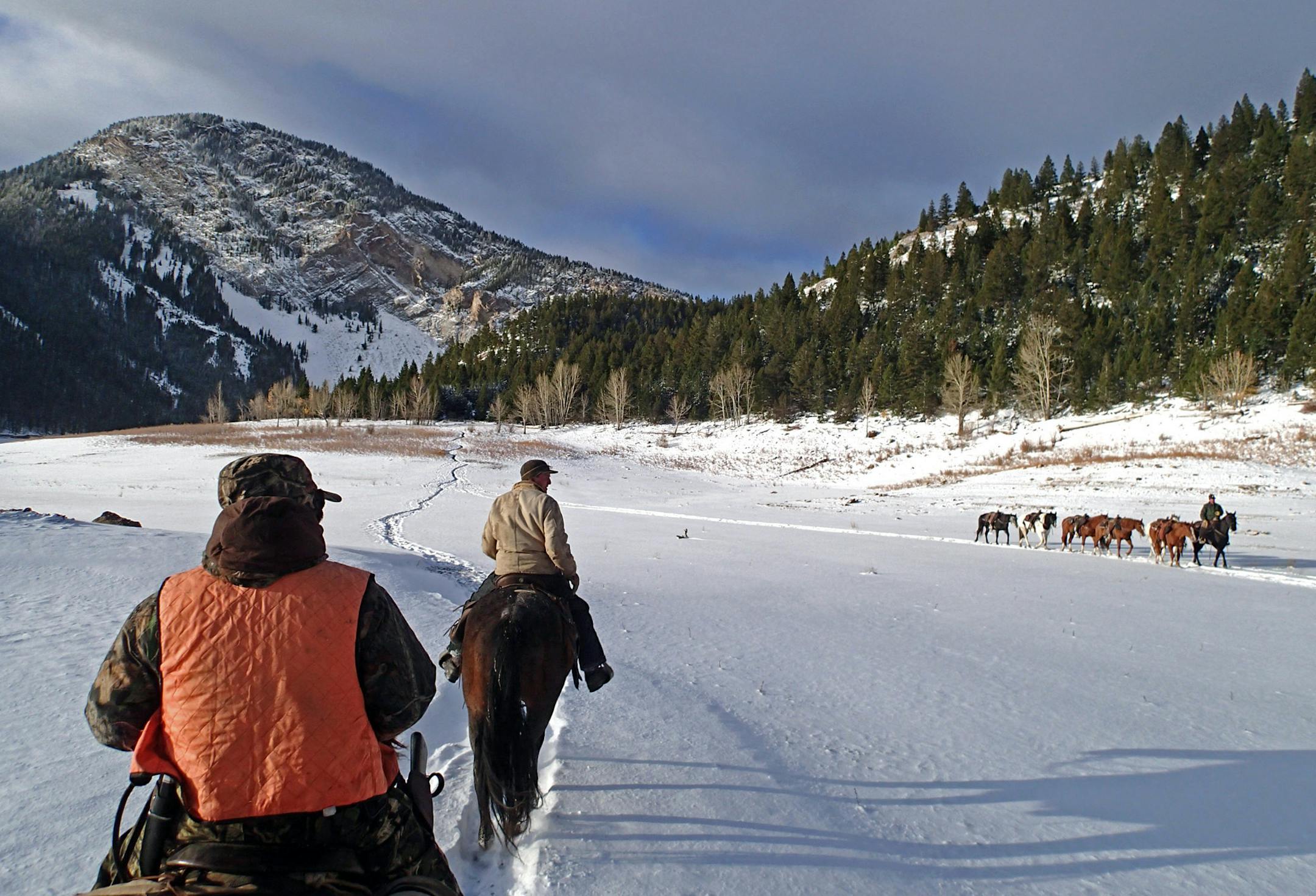 Frigid winter temperatures and strong winds greeted hunters on an 18-mile ride into the Bob Marshall Wilderness. Guide Logan Sheets, 21, of Wausau, Wis., rode ahead, with Rod Boyer of Kent, Wash. following. A pack string, meanwhile, was headed out of the wilderness and to lower elevations and somewhat higher temperatures.