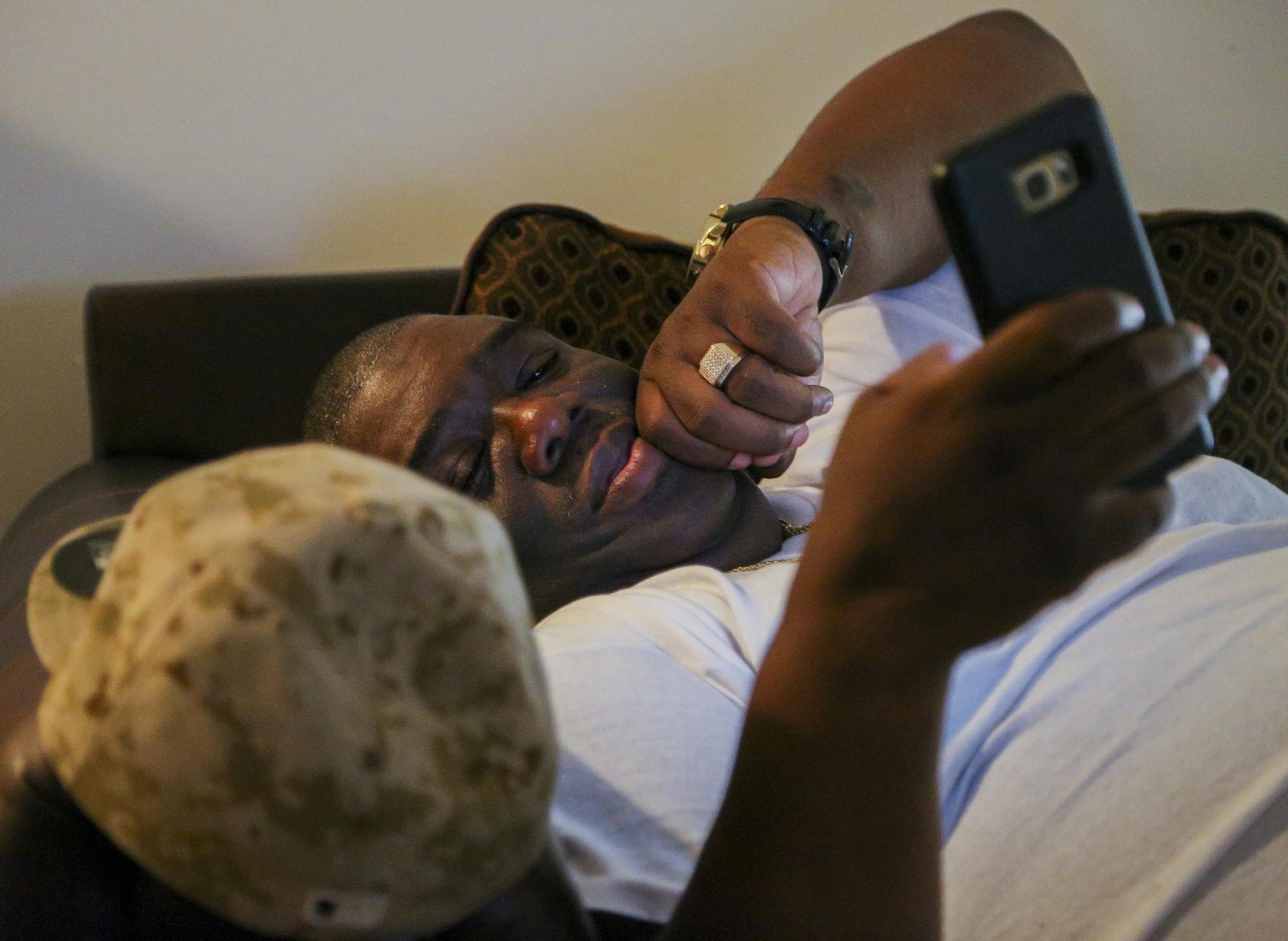 Ferome Brown rests at his home after visiting the site of a shooting at the 1100 block of W. Broadway on Sunday, July 3, 2016. Brown will typically visit the site and meet with families affected by gun violence in north Minneapolis as well as meet with members of cliques and gangs to work as a mediator.