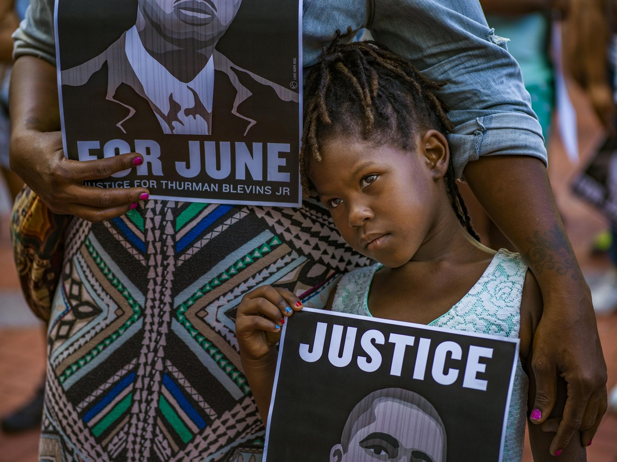 Zaina Fields,6, stood with her mother LeRoyce Walker who brought her to the Hennepin Government Center Plaza to protest the killing of Thurman Blevins. "They did not give him the benefit of the doubt because of the color of his skin," said Walker.